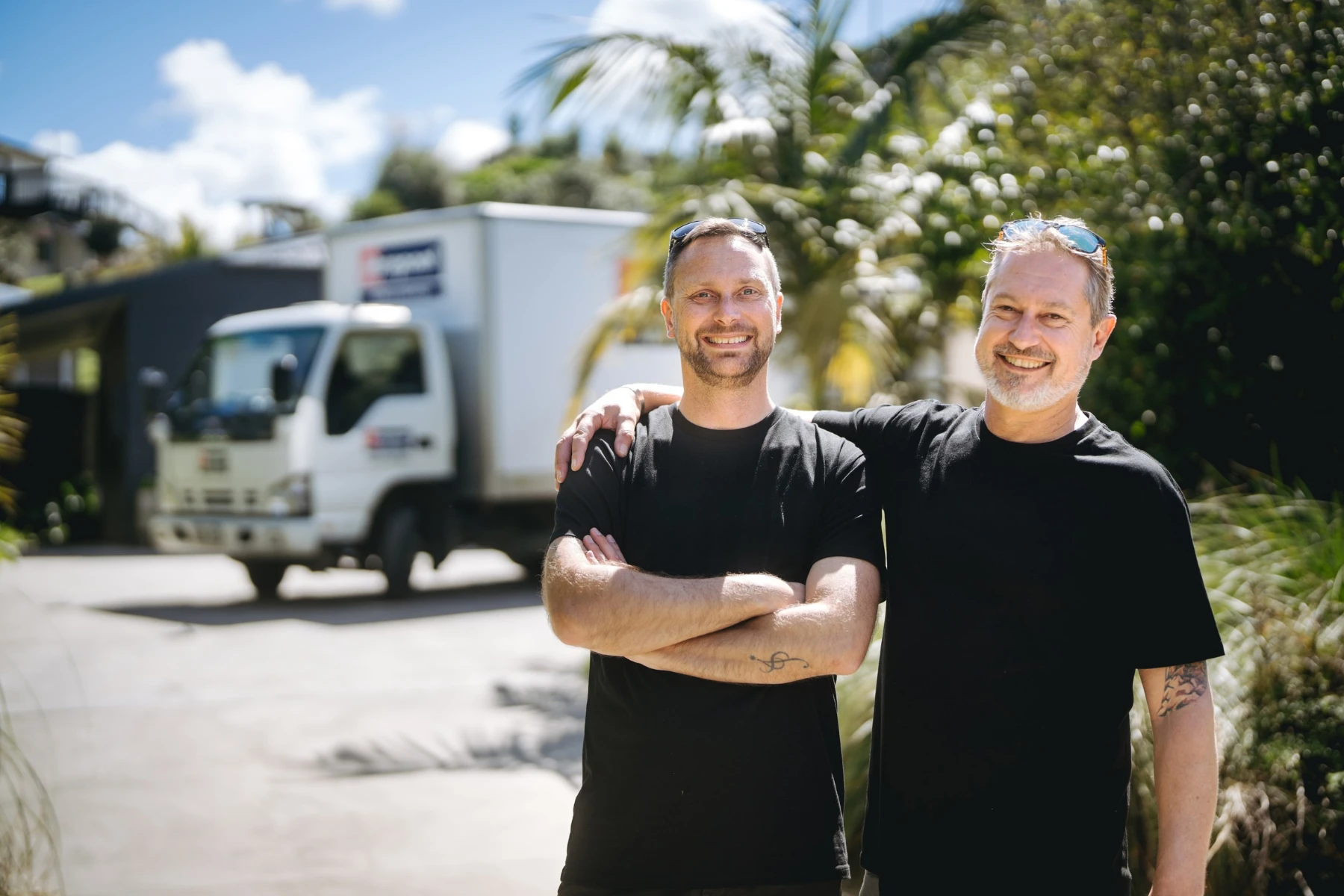 two removalists standing in front of truck