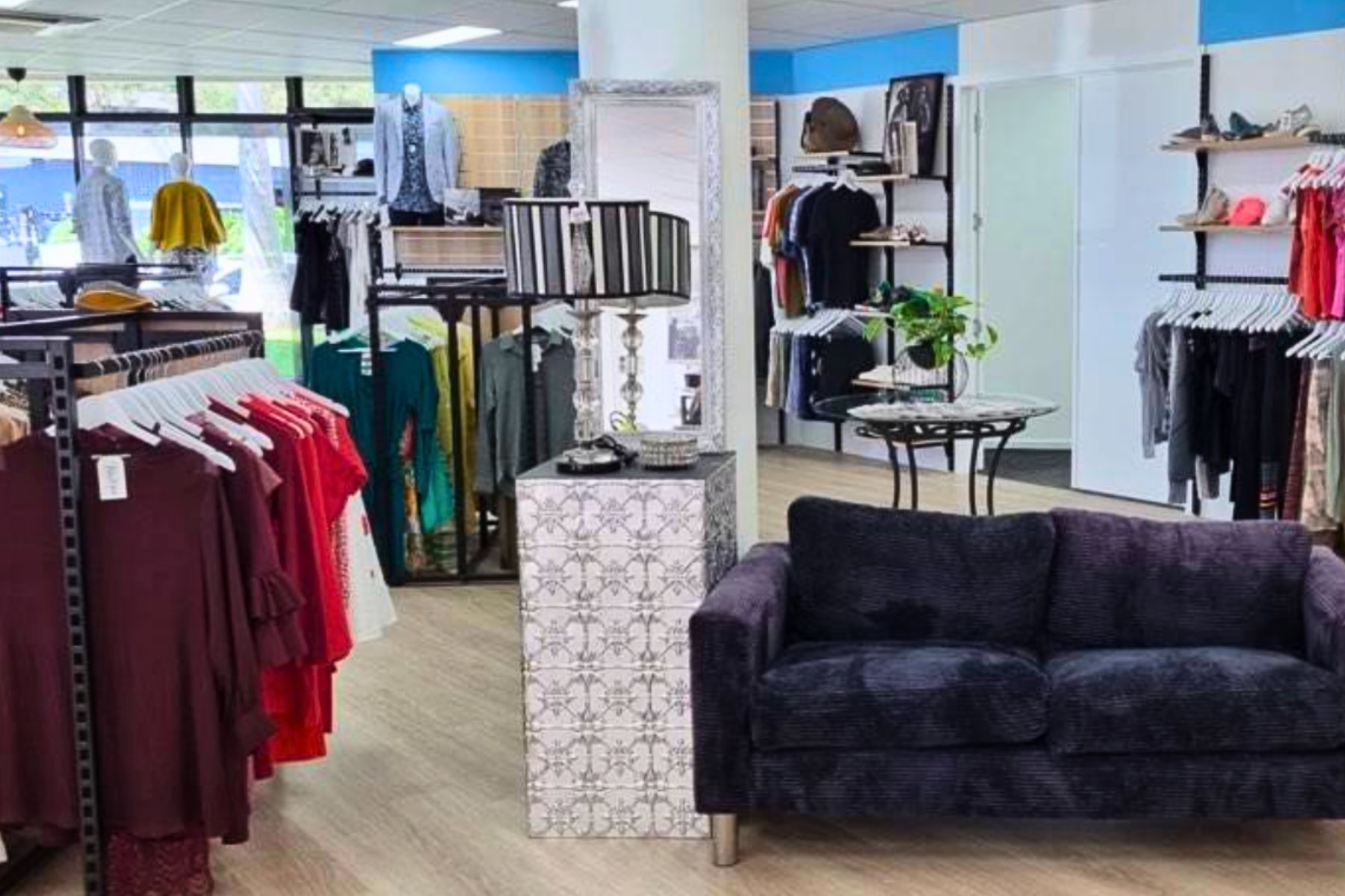 second hand store with clothes and couch