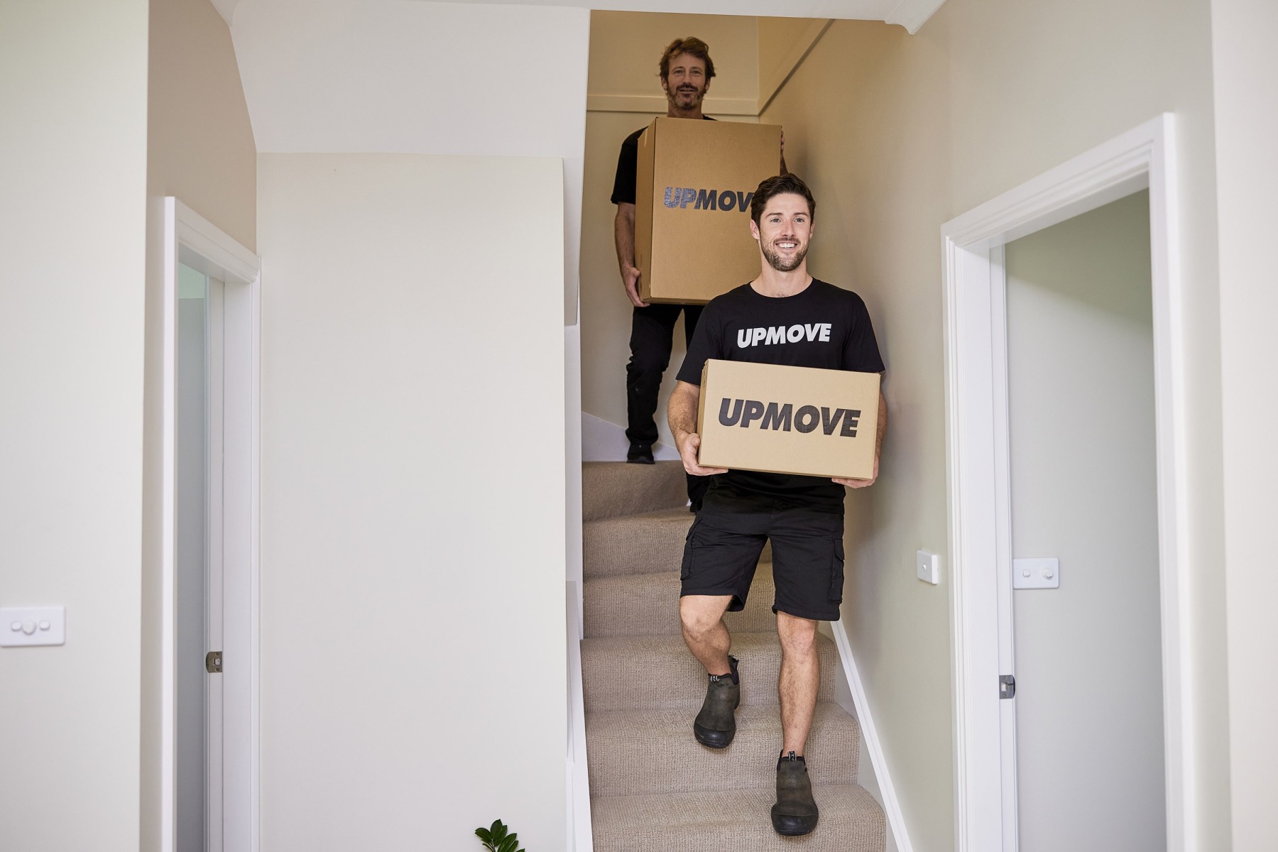 Removalist from a student moving team carrying boxes for a small move
