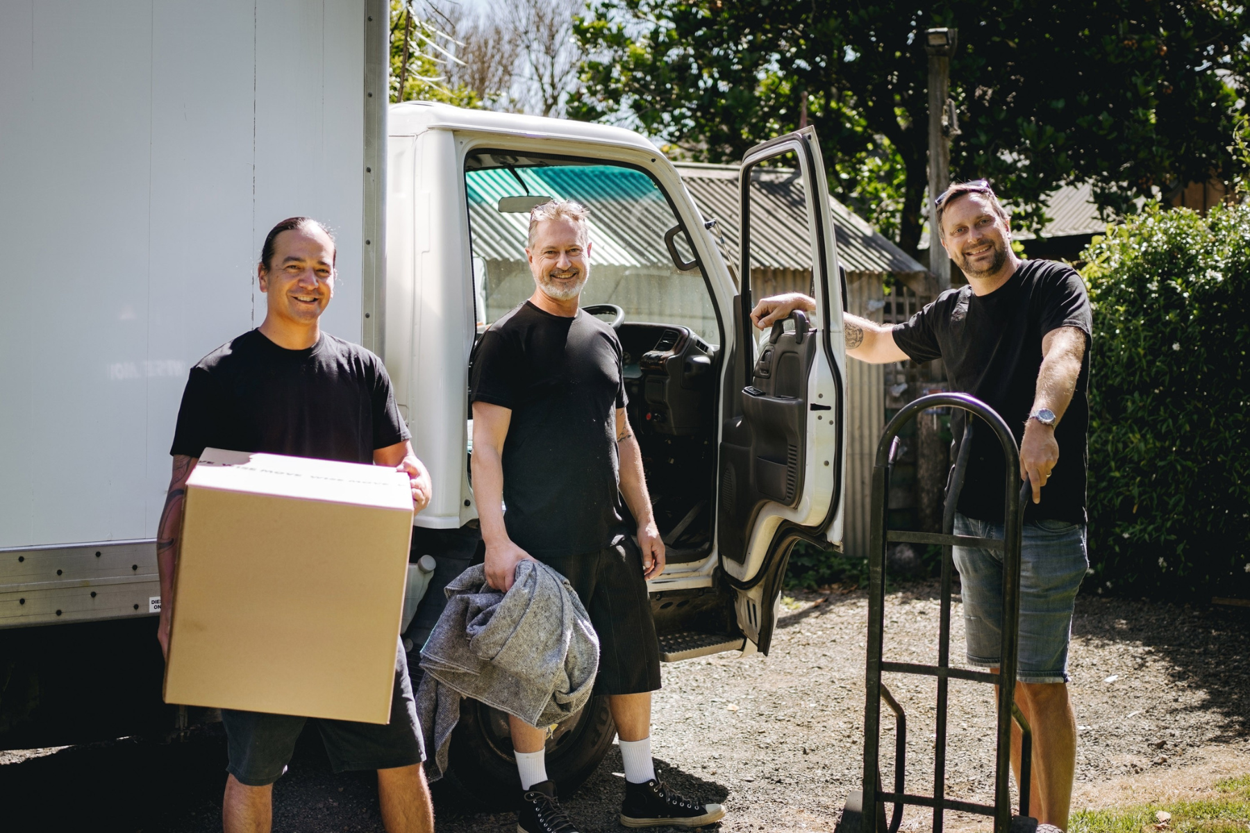 three removalists standing near truck