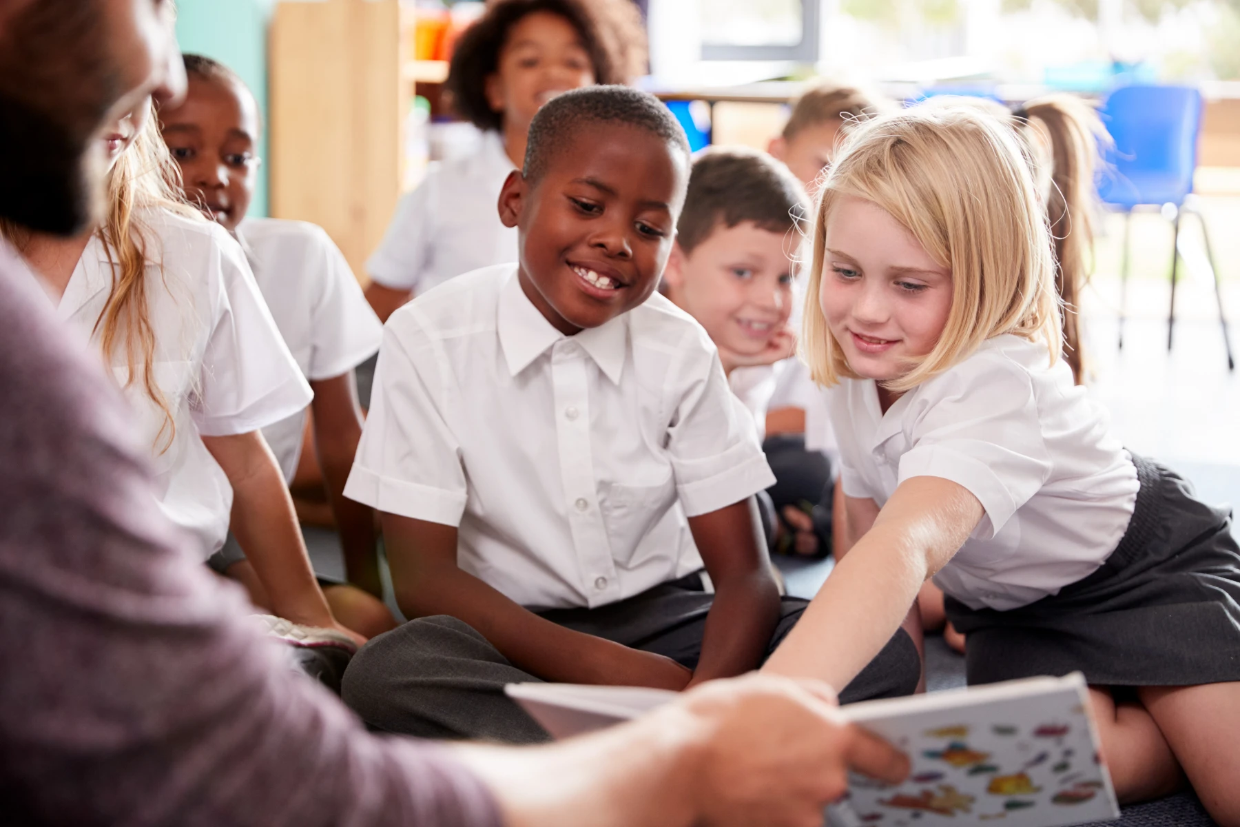 primary school kids sitting on the floor