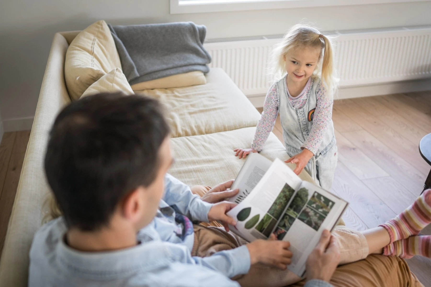 Father reading a book to children