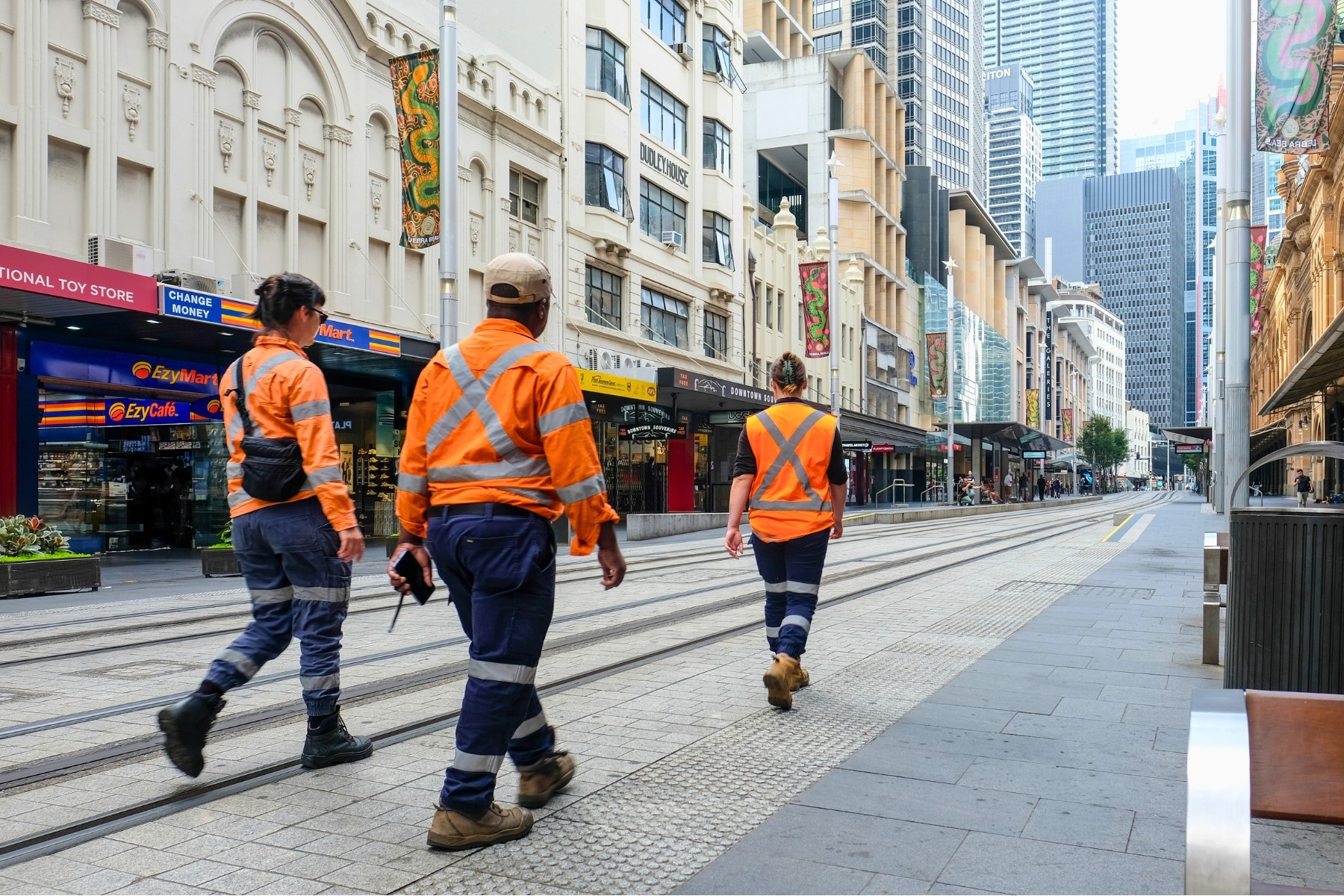 walking down a street toward a job site in Sydney, Australia