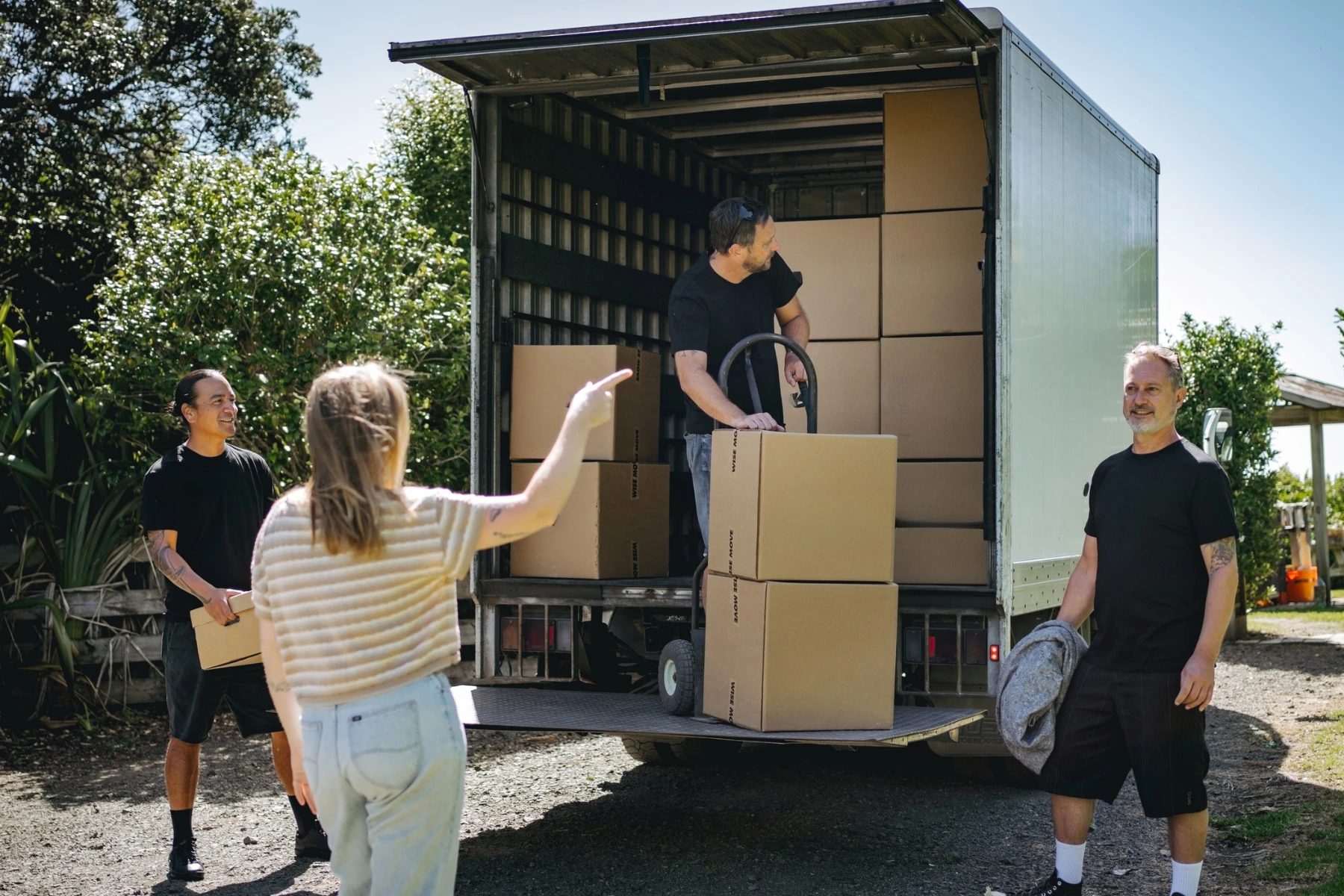 3 removalists and home owner with removalist truck