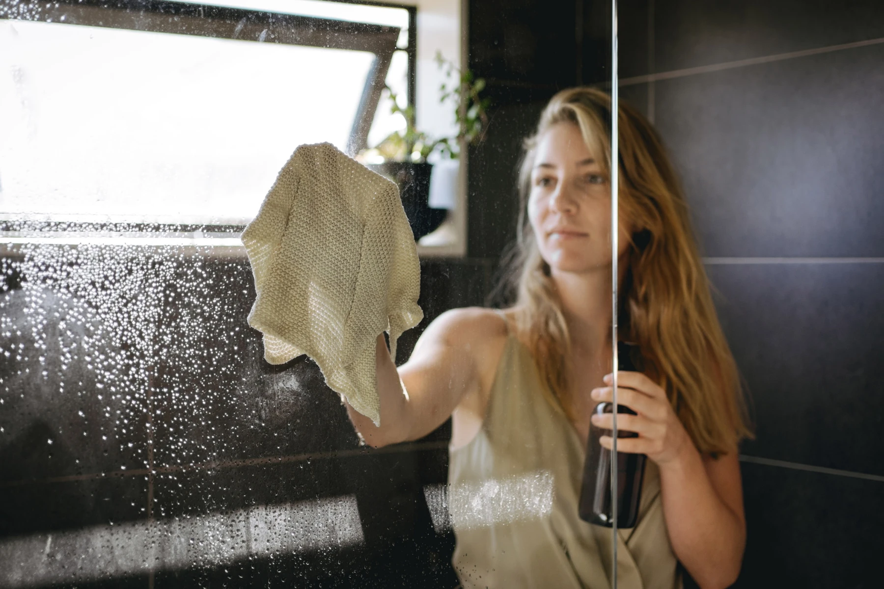 woman cleaning bathroom