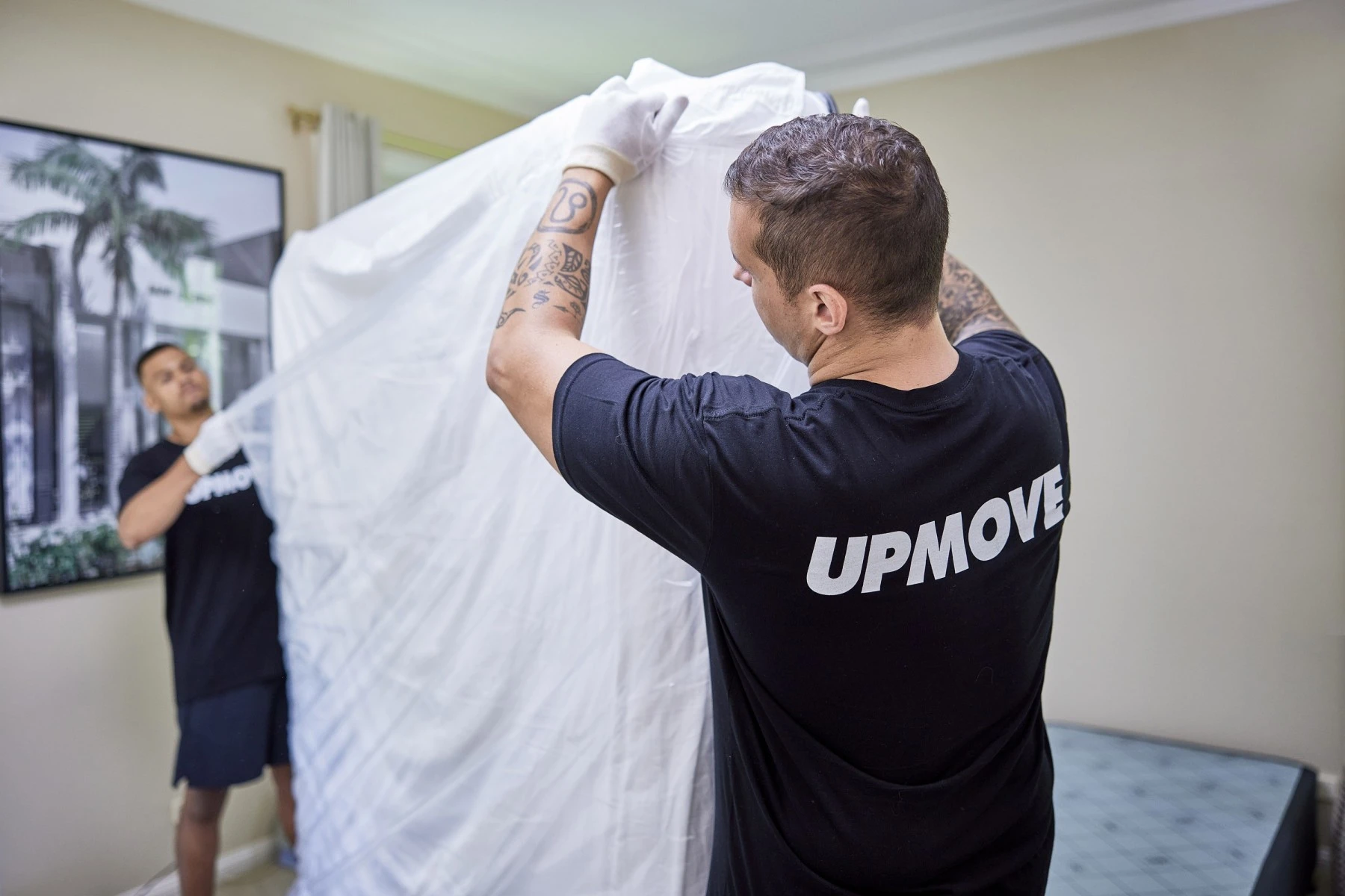 removalists wrapping mattress in plastic