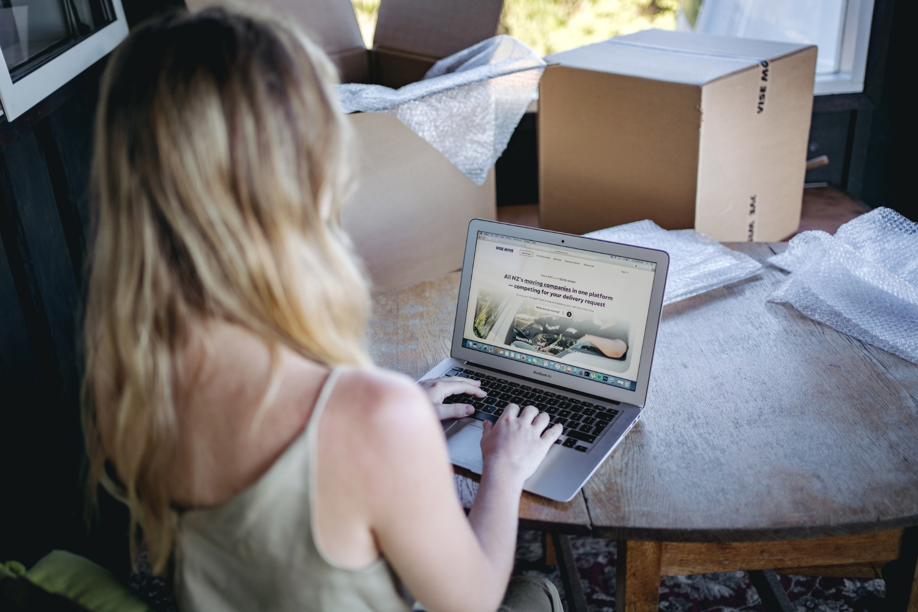 woman sitting at table with laptop