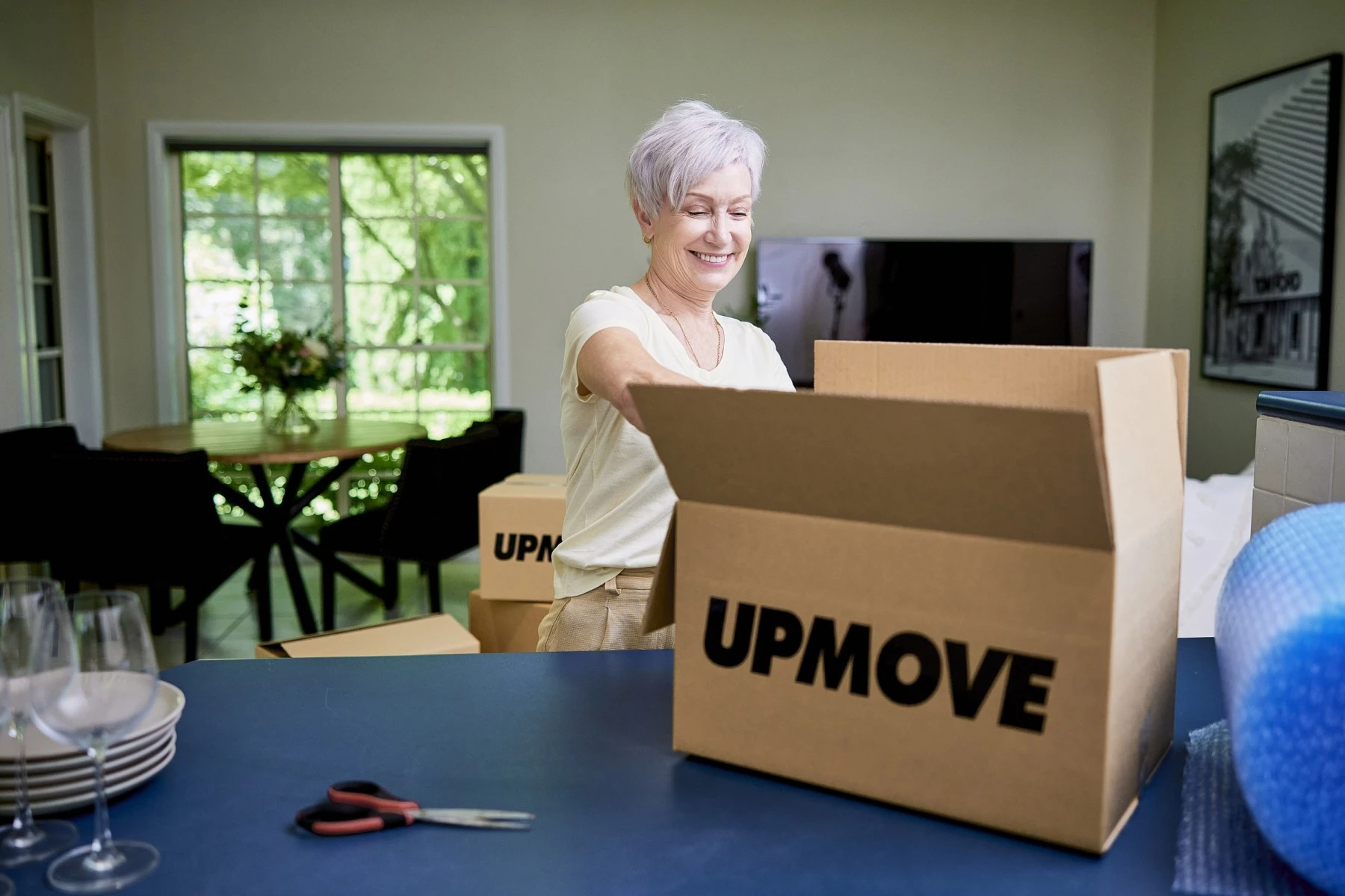 woman packing removalist box