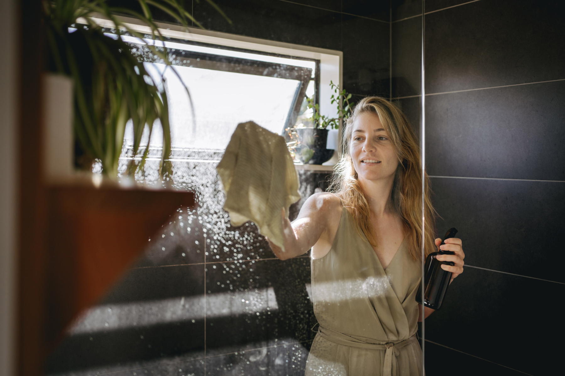 woman cleaning bathroom