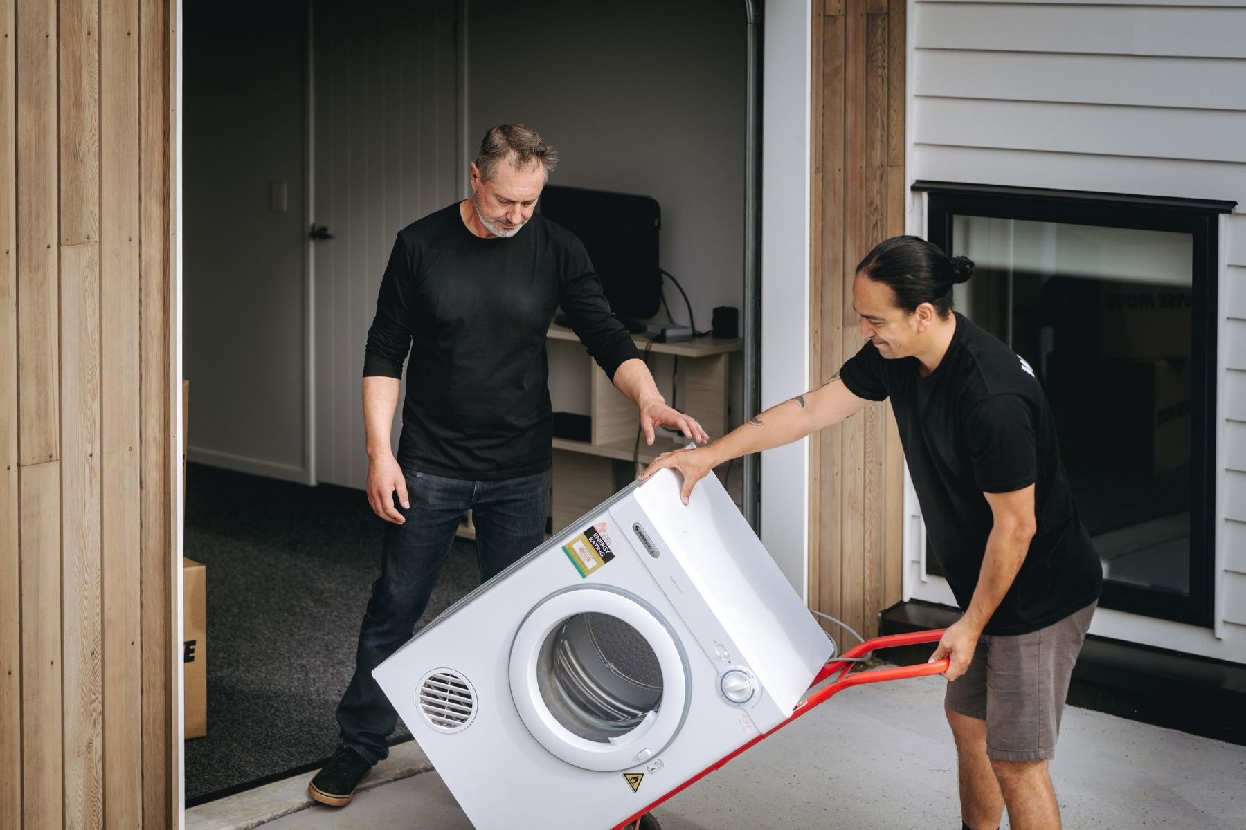 removalists with washing machine on trolley