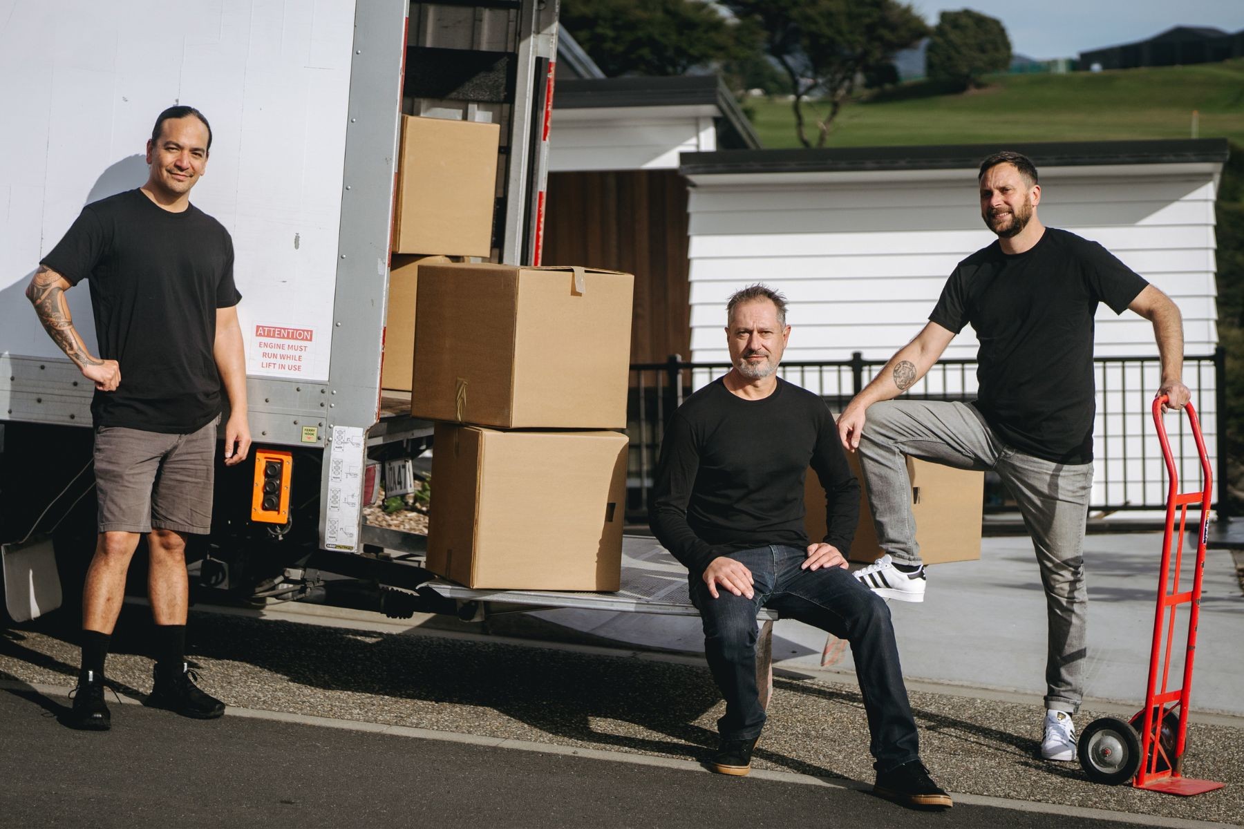 removalists sitting in back of moving truck