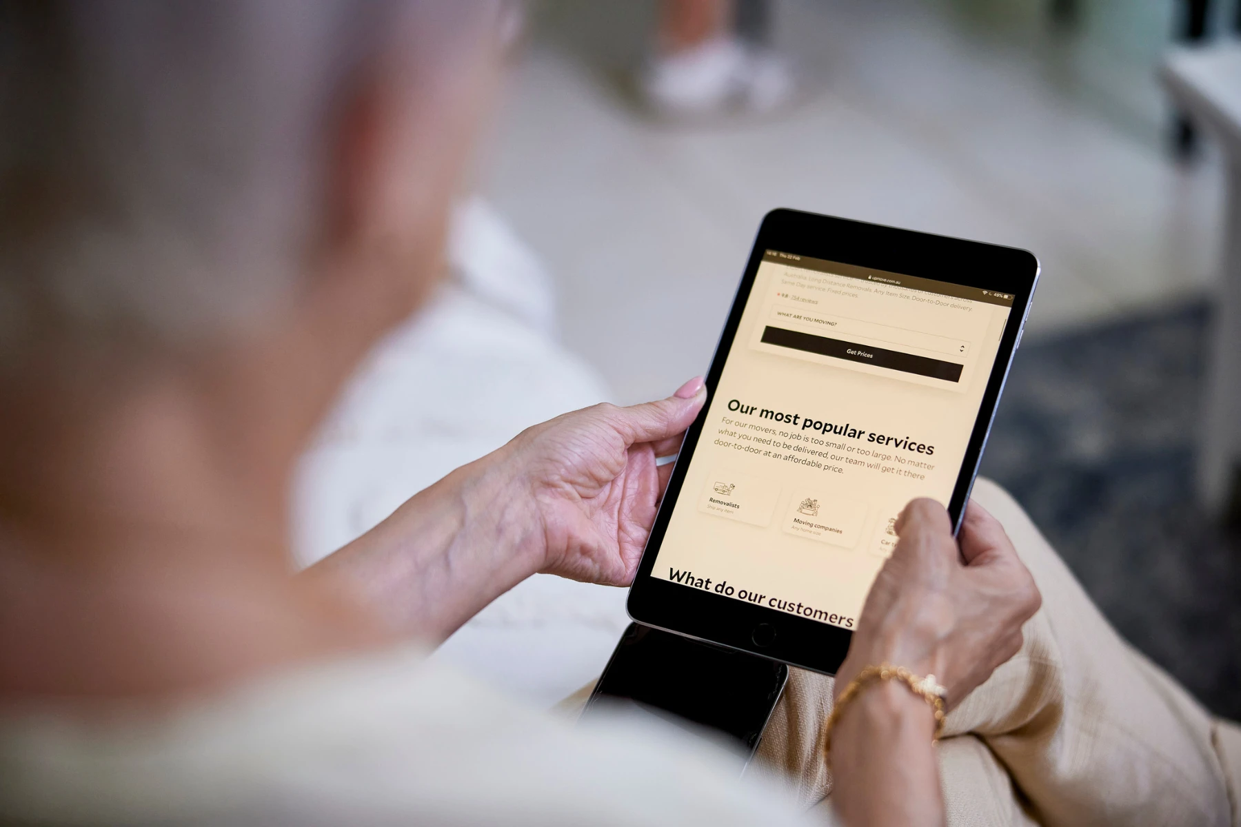 woman holding tablet with removalist website