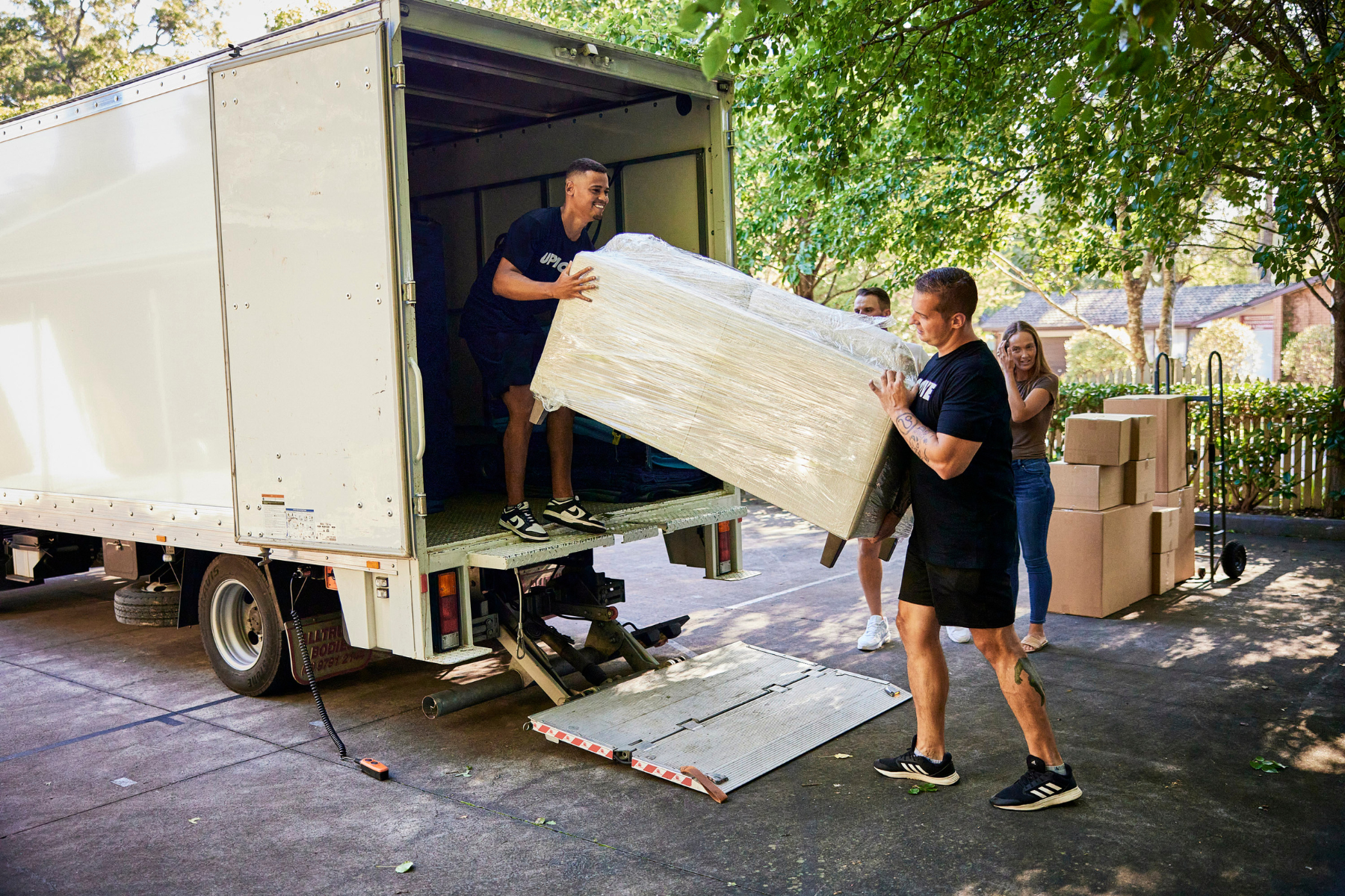 Professional removalists loading coach into moving truck for a student move