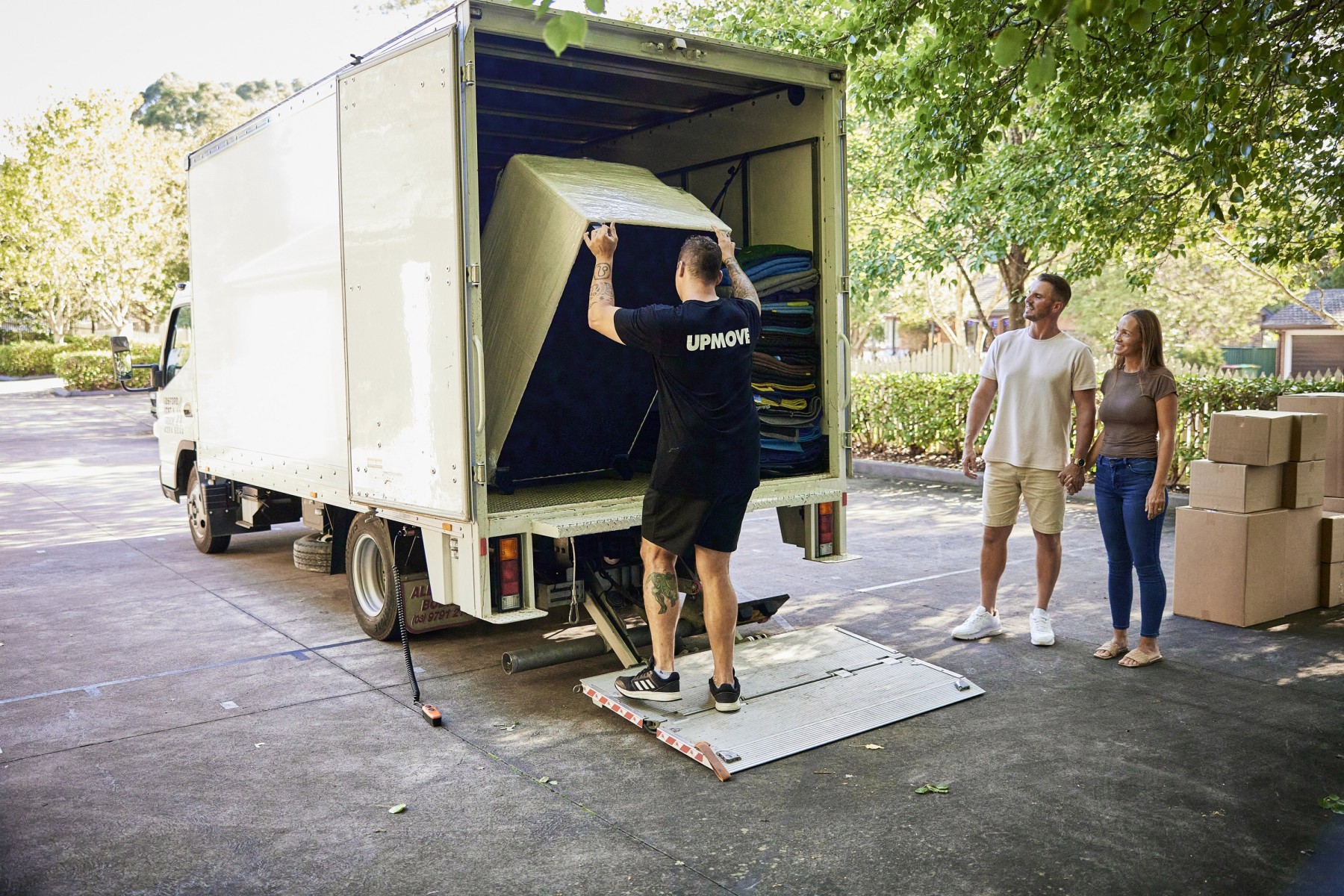 removalist moving couch into a truck