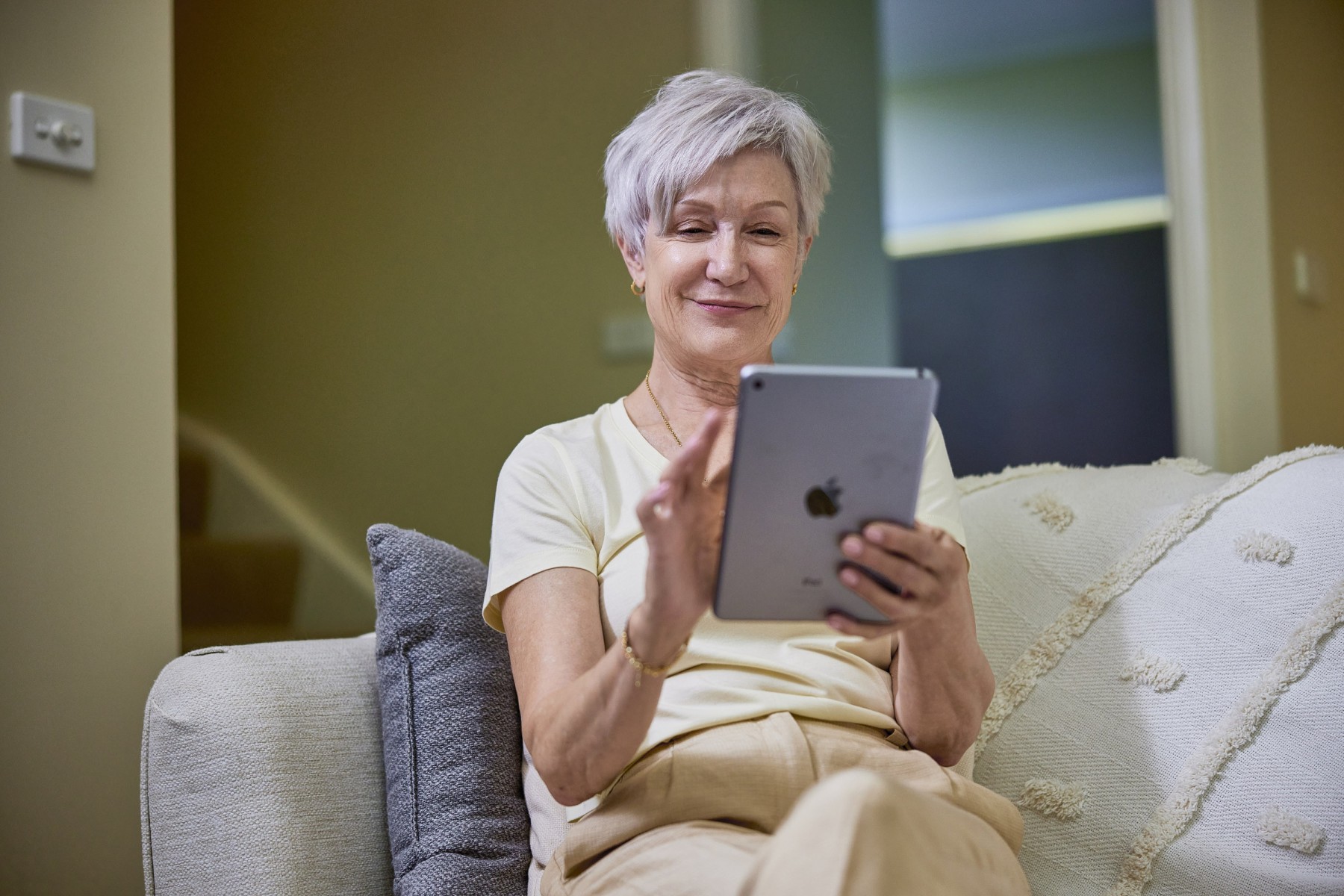 retired woman looking at tablet