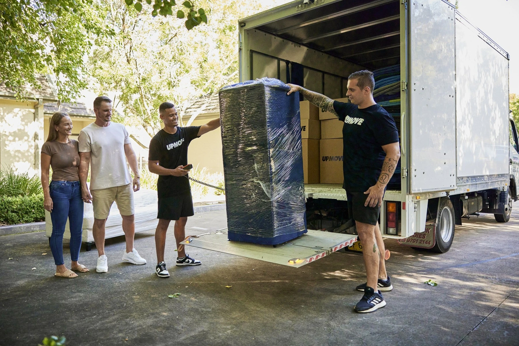 Removalists loading a fridge in truck for a backloading interstate move