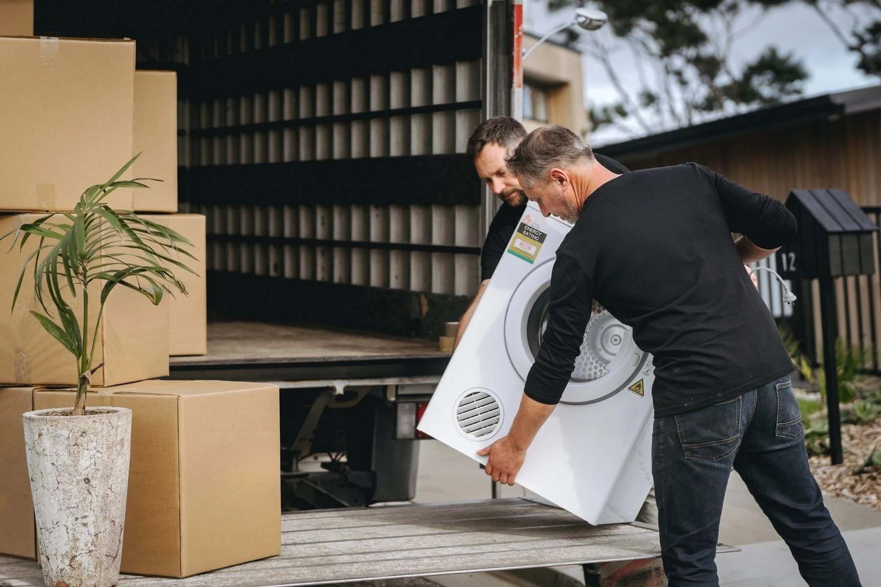 removalists putting washing machine on truck