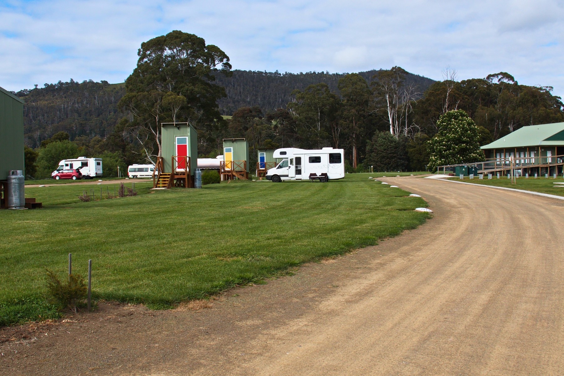 View of Huon Valley Caravan's facilities with farmland and forest in background