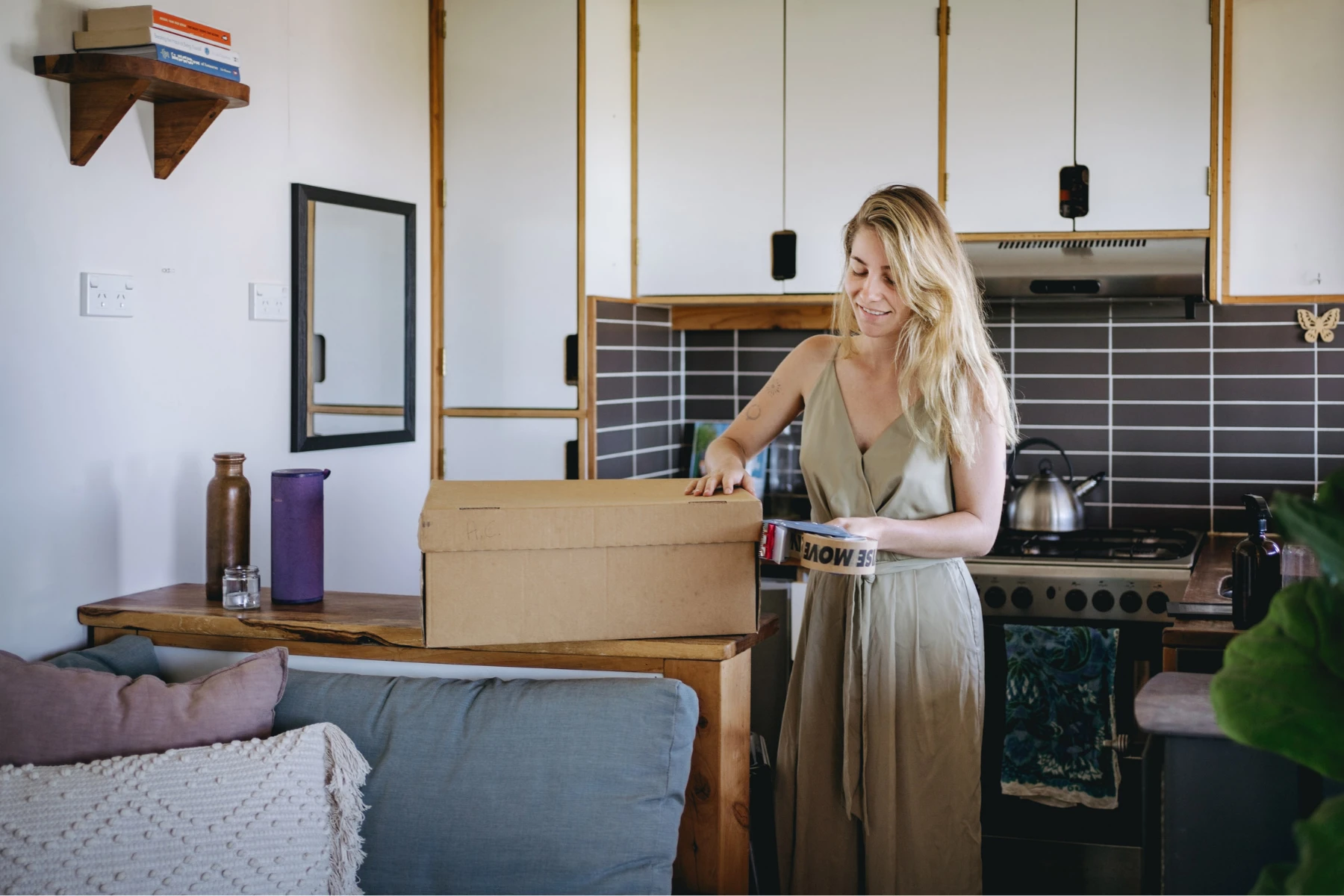 woman with moving box and tape