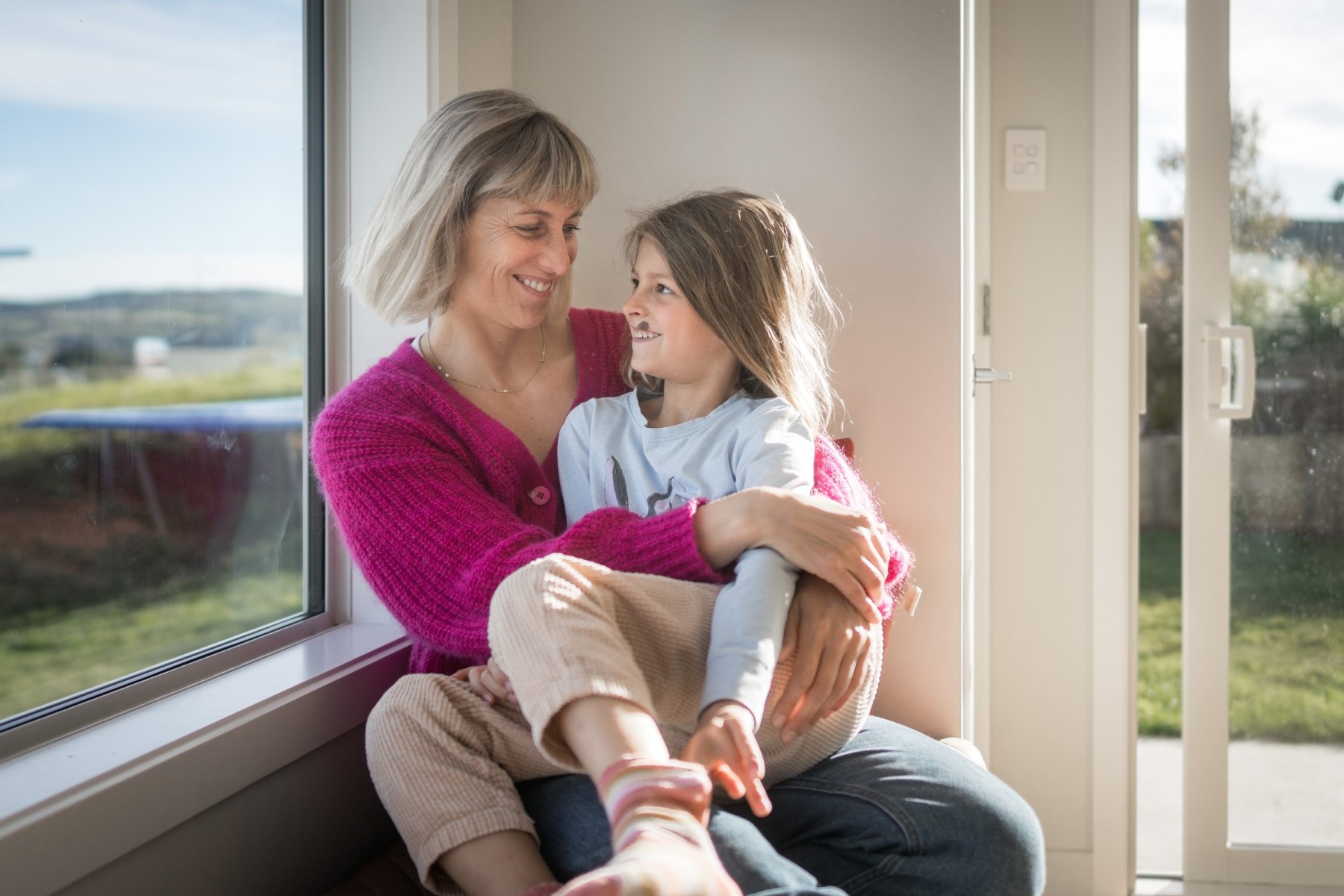mother hugging daughter