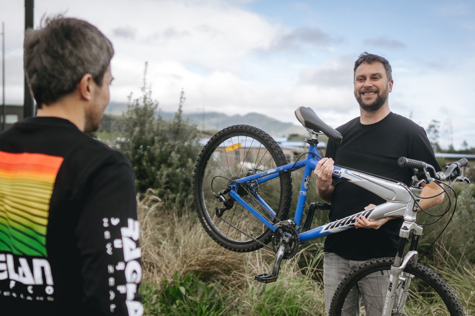 homeowner with removalist carrying bike