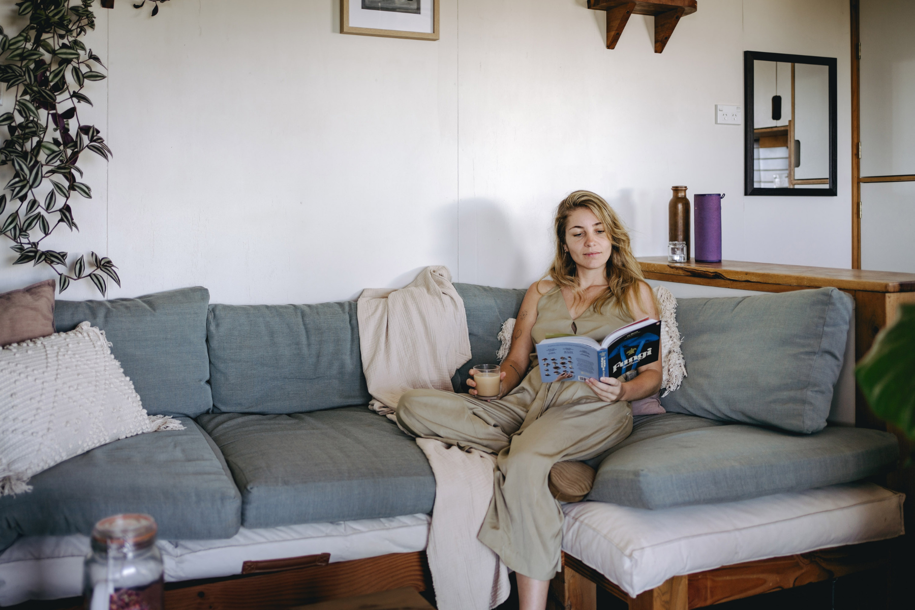Woman settled on couch in newly unpacked living room after moving