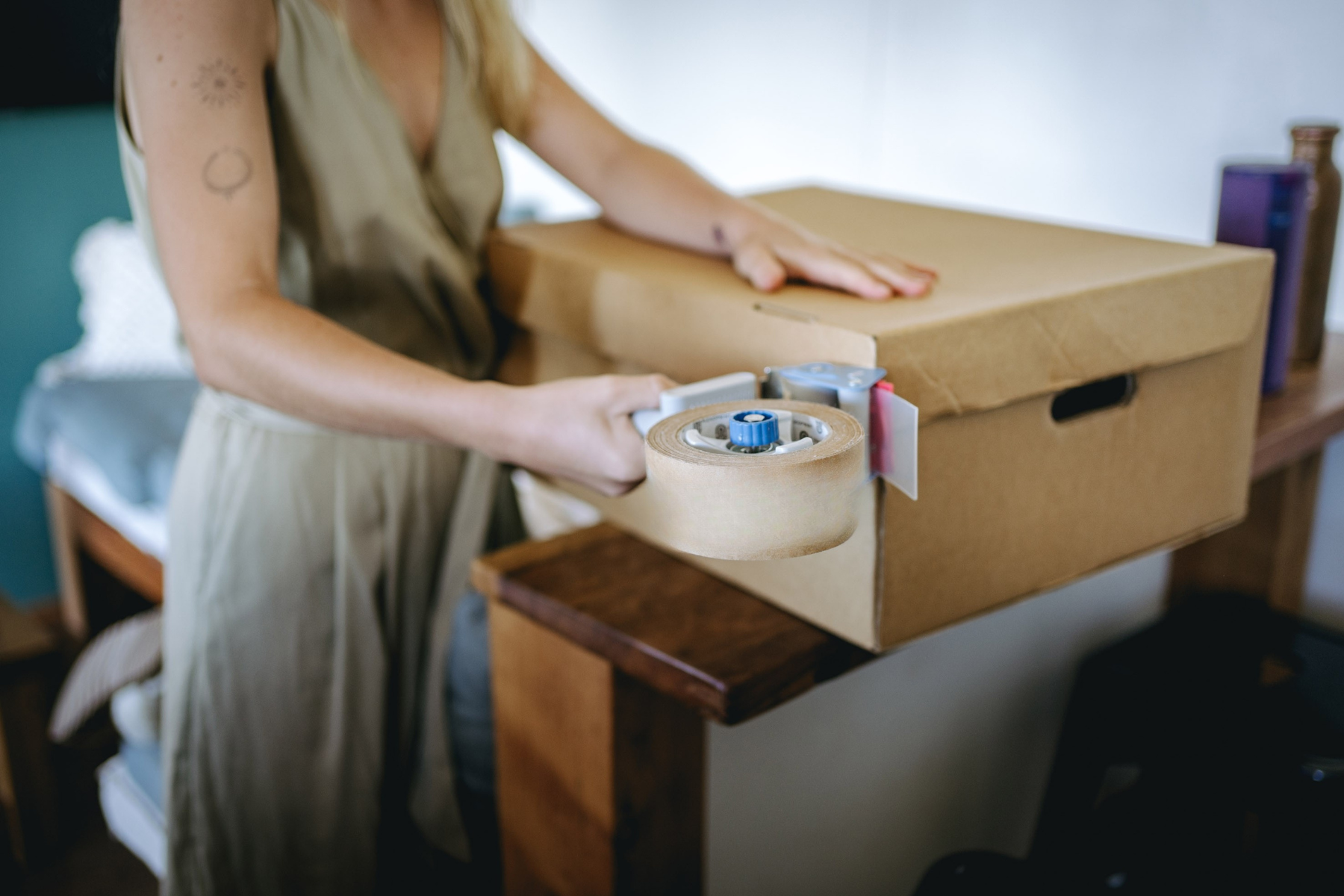 woman taping up moving box.png