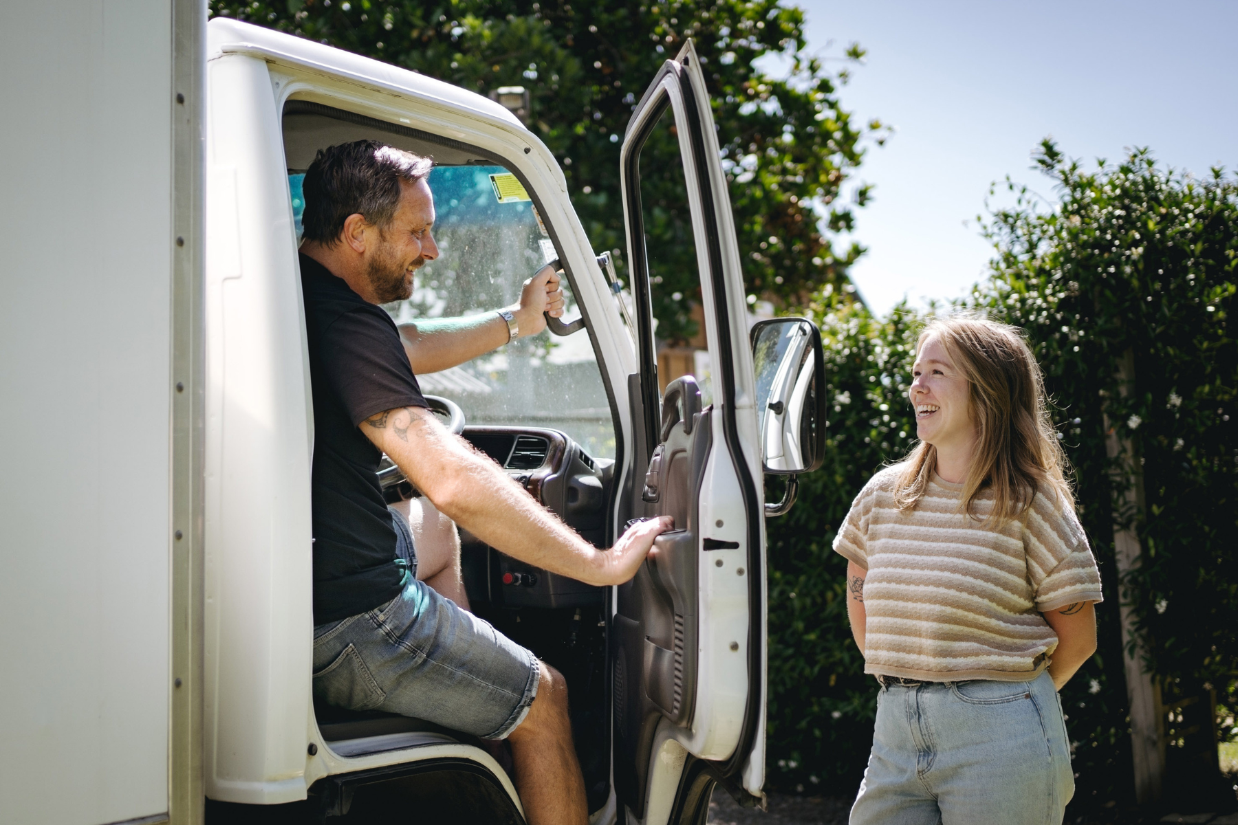 removalist in van talking to woman