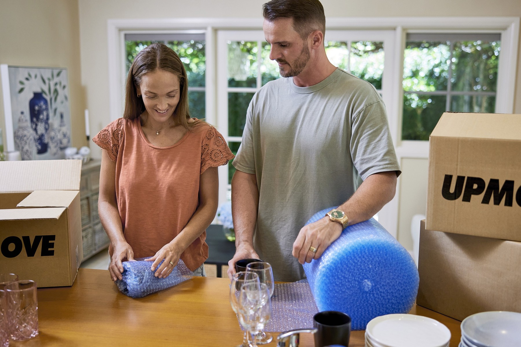 Student packing up box of kitchen items to take with her to student accommodation