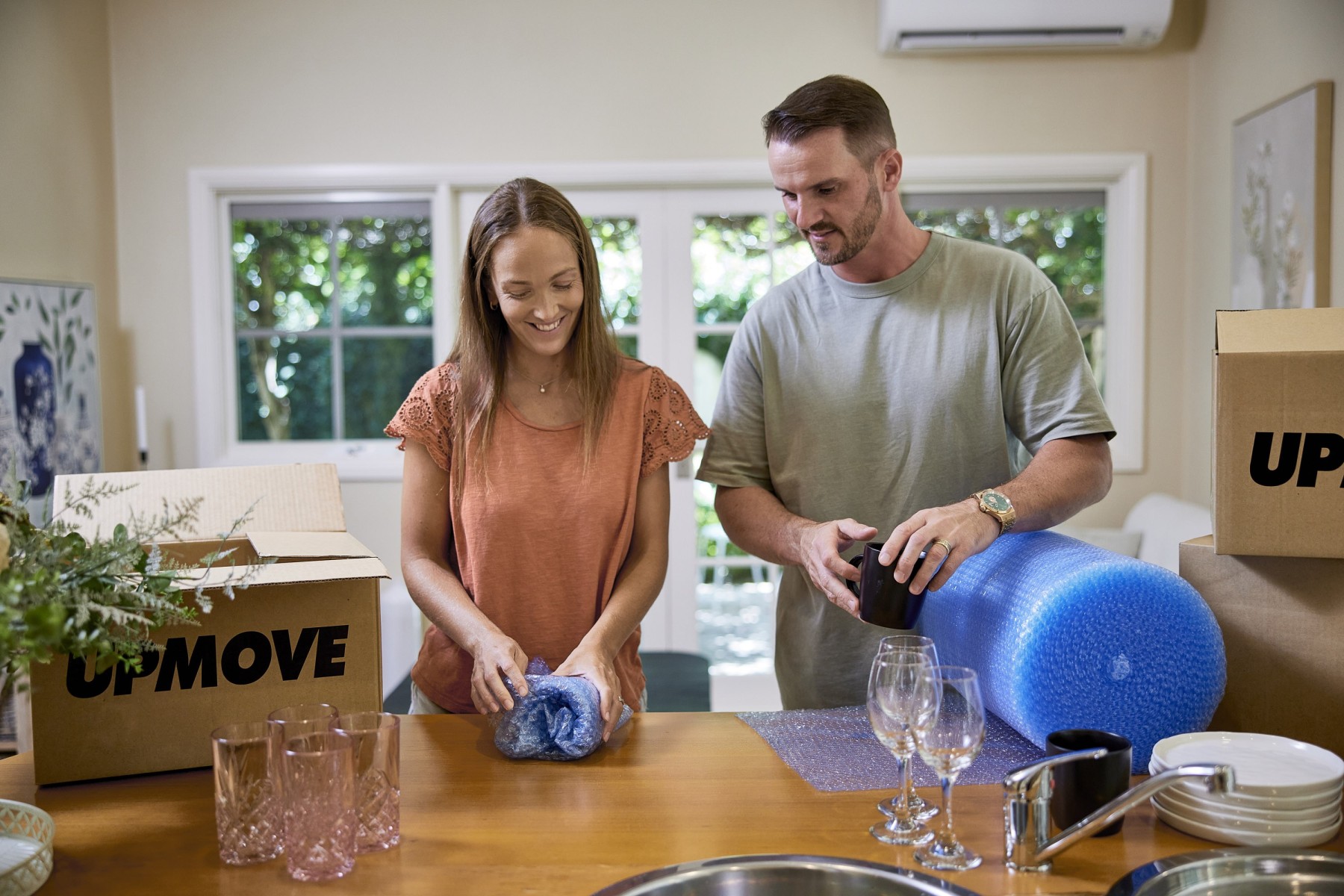 man and woman wrapping glasses