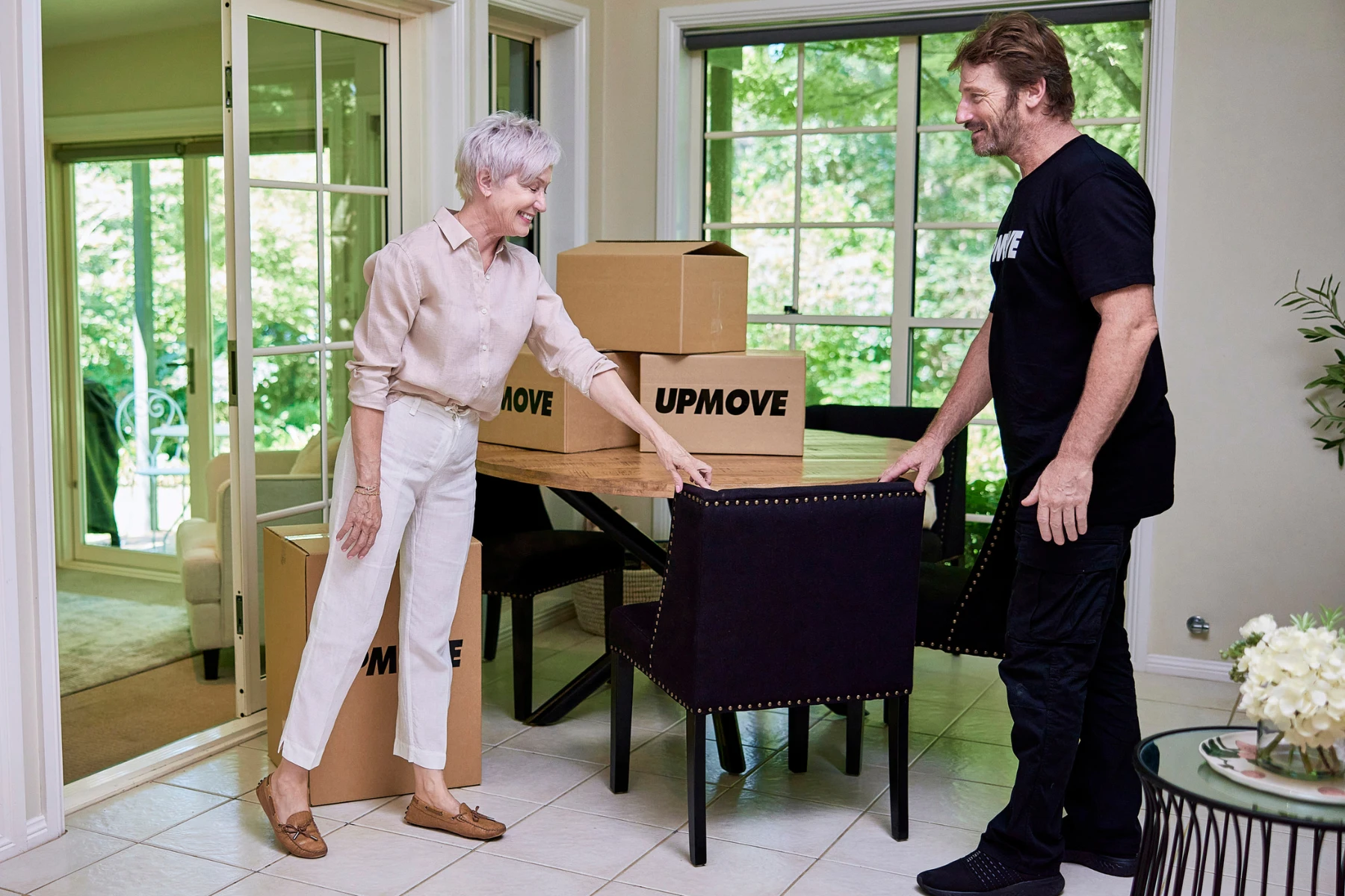 woman and removalist standing near chair