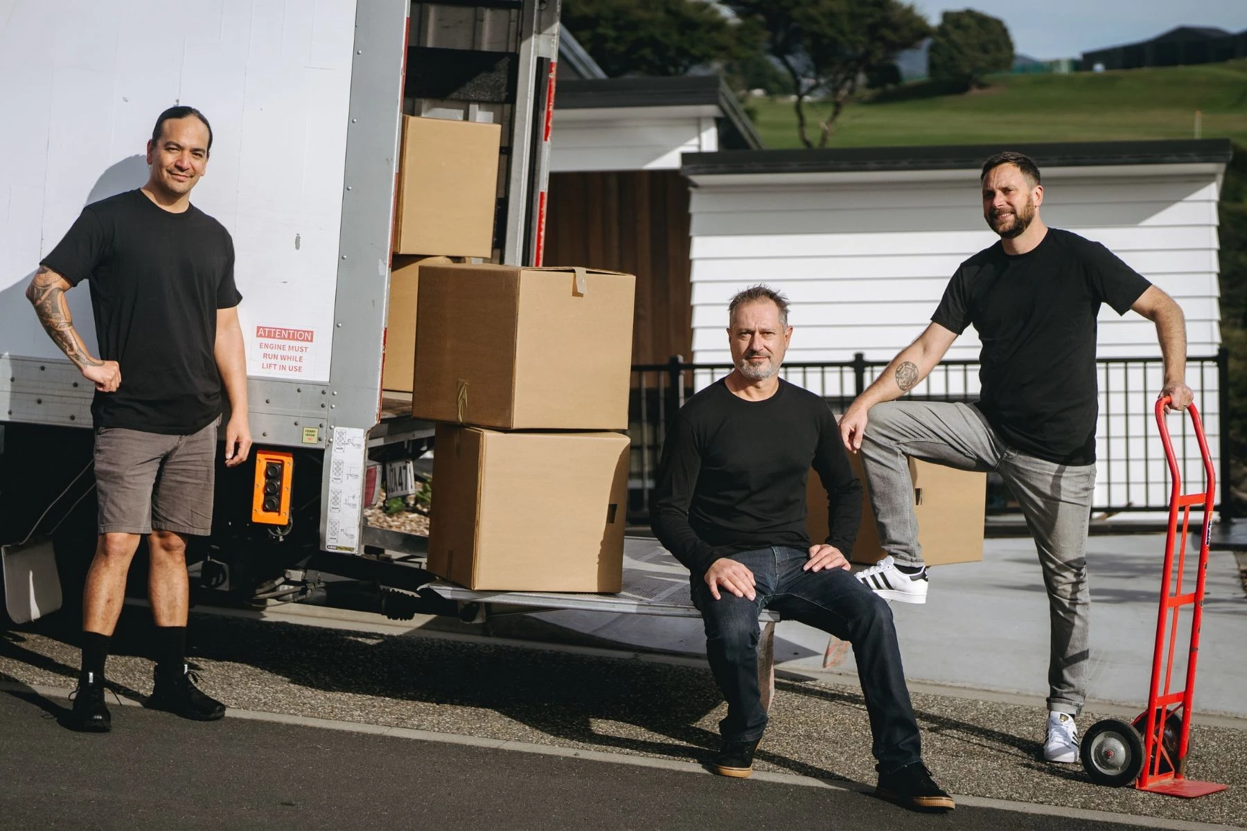 removalists sitting in back of moving truck