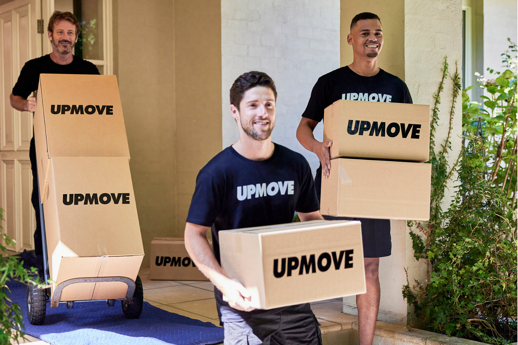 Upmove removalist team carrying donation boxes for pre-Christmas pick-up