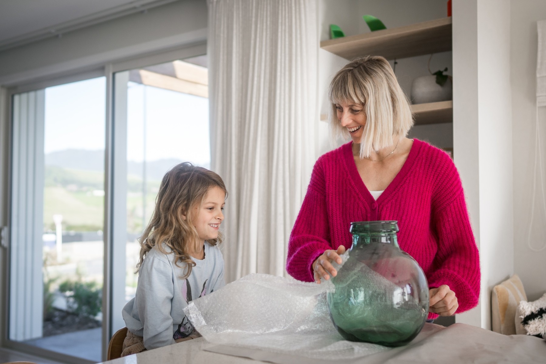 mother and daughter wrapping with bubble wrap