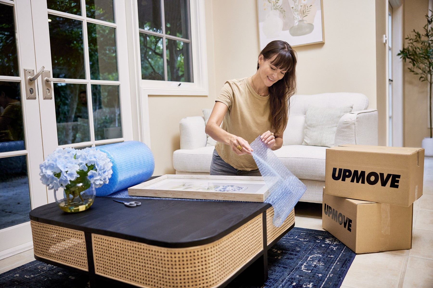 woman packing with bubble wrap