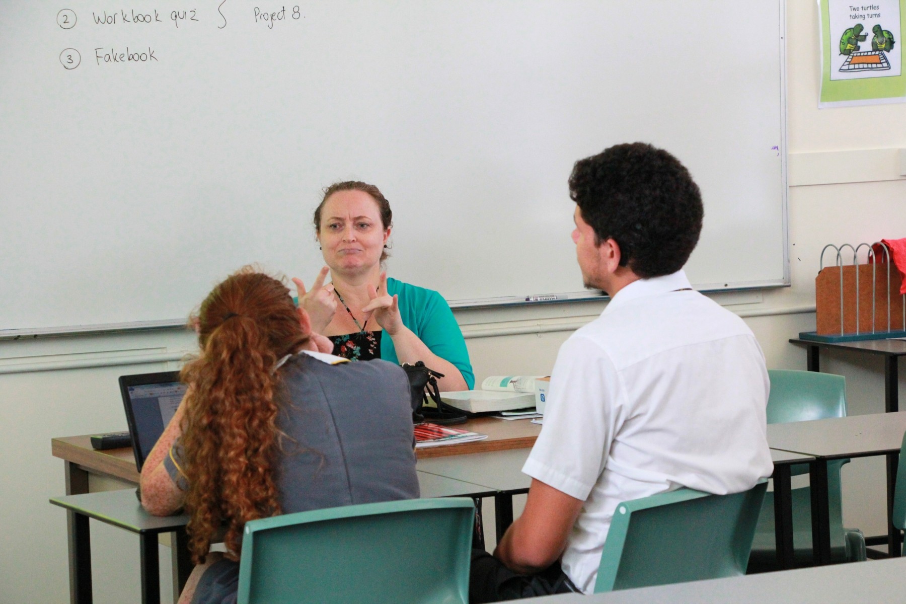 Teacher in classroom with school students in Australia