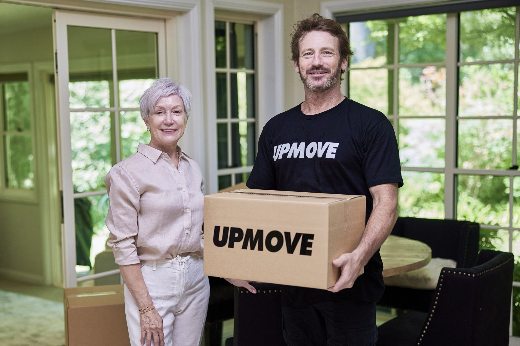 Women hiring professional removalist to help her move glassware