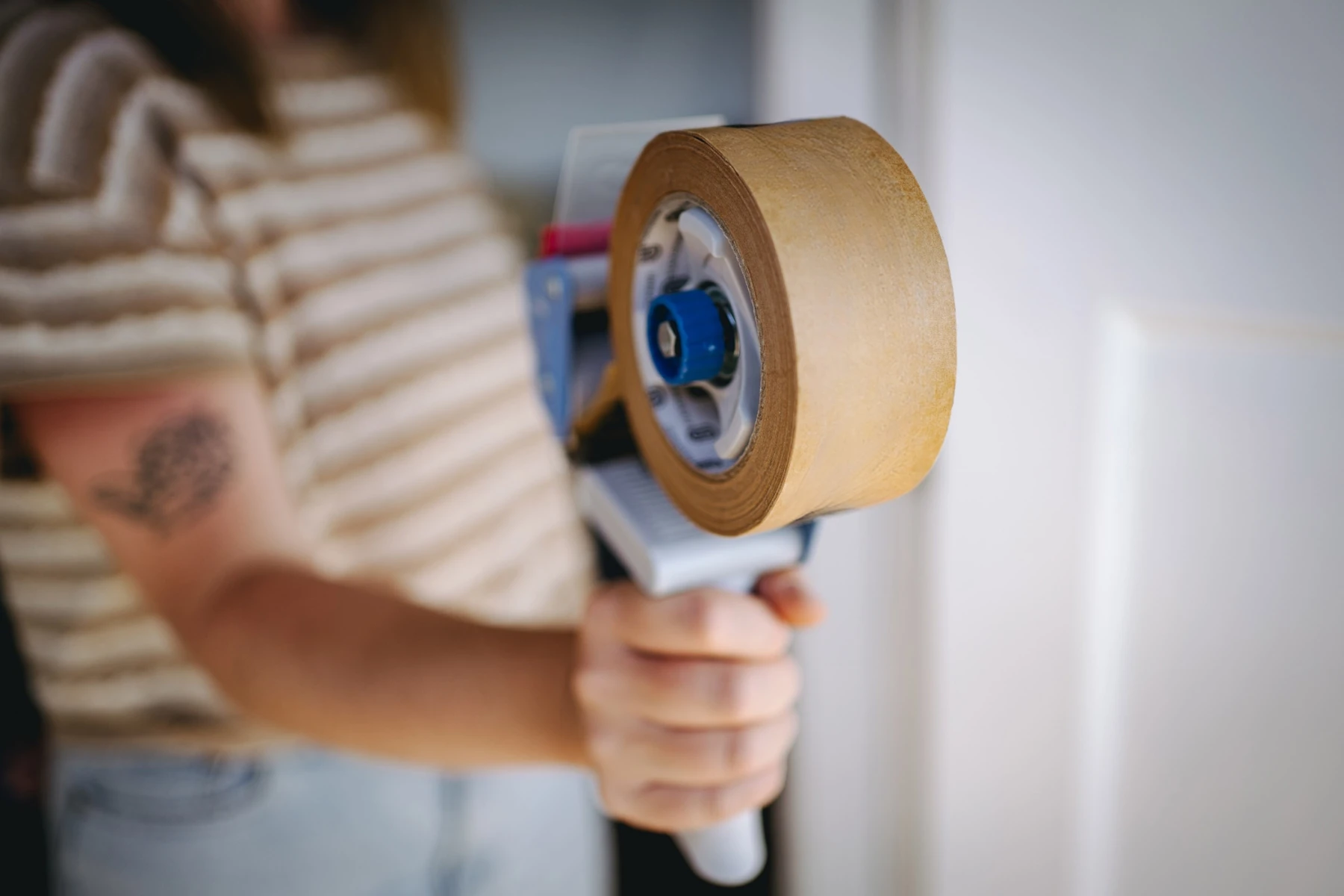 woman holding packing tape