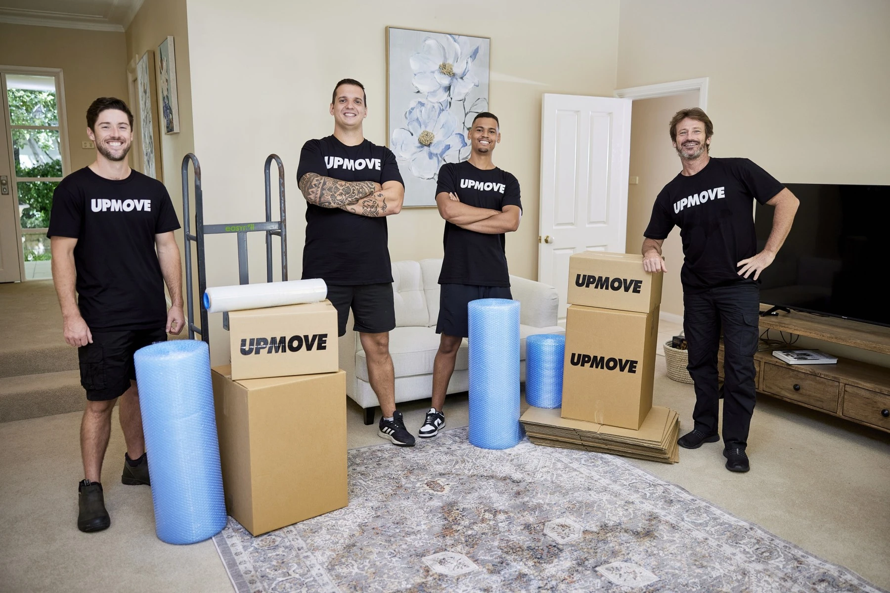 four removalists withboxes and bubblewrap