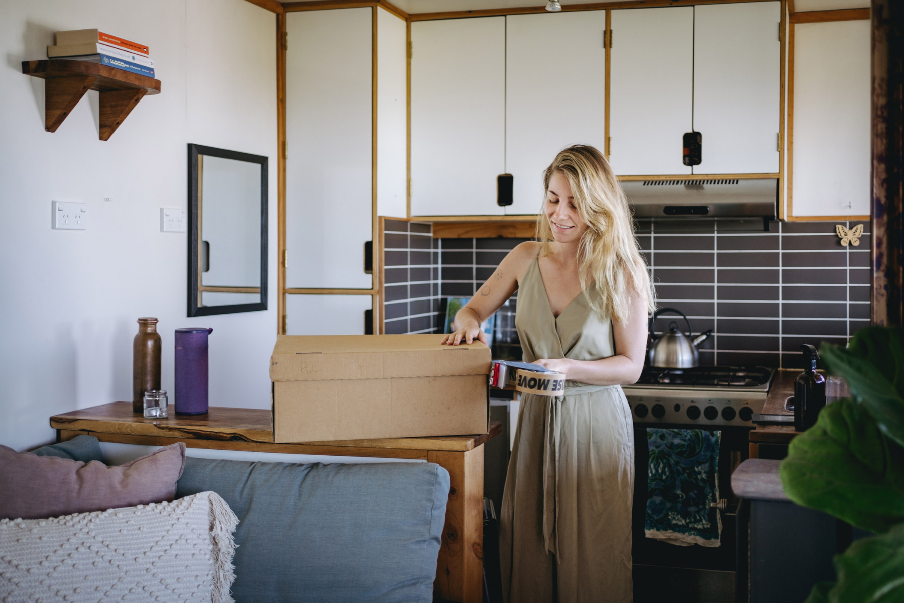 woman with packing tape and moving box