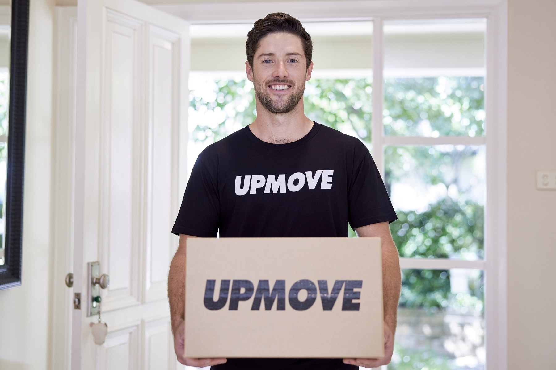 removalist with moving box in office