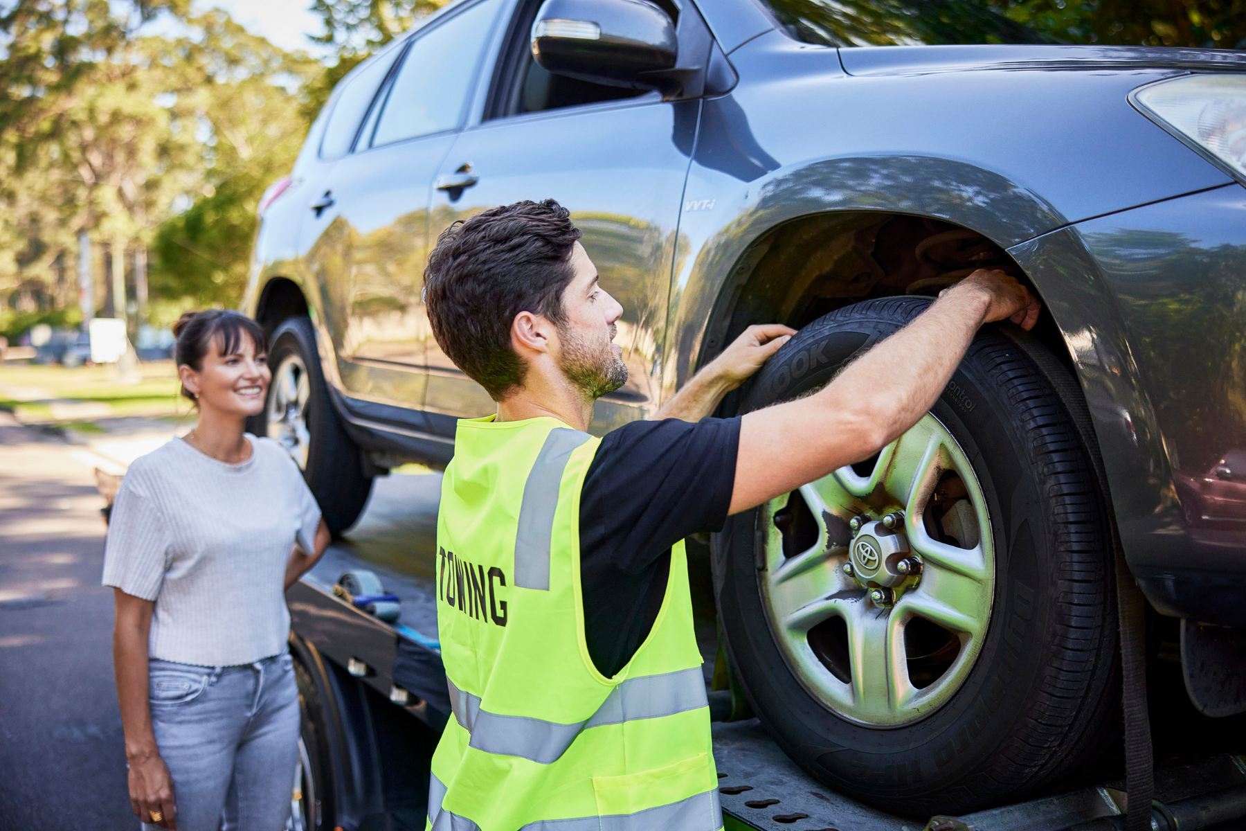 Vehicle inspection on a car carrier truck in Australia before transport, checking tyre safety and condition