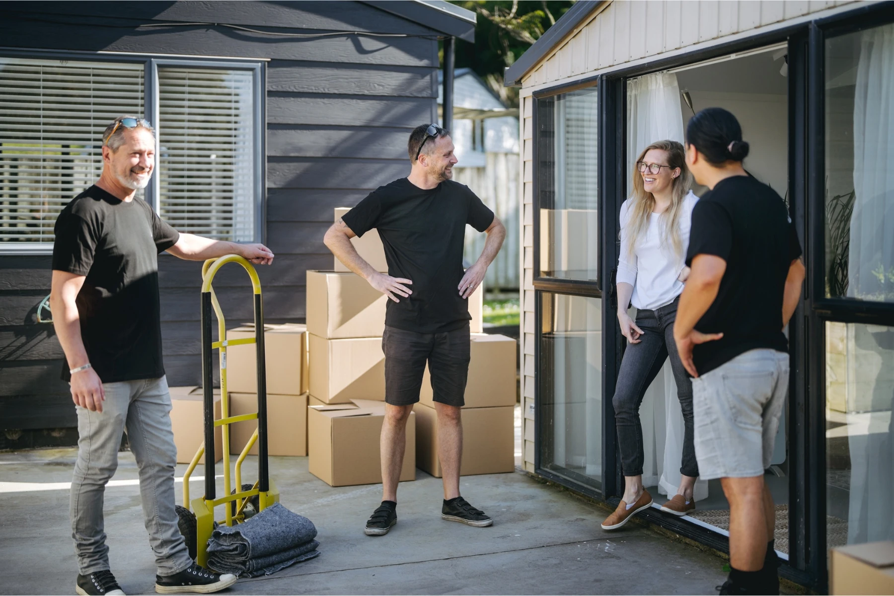 three removalists chatting homewoner