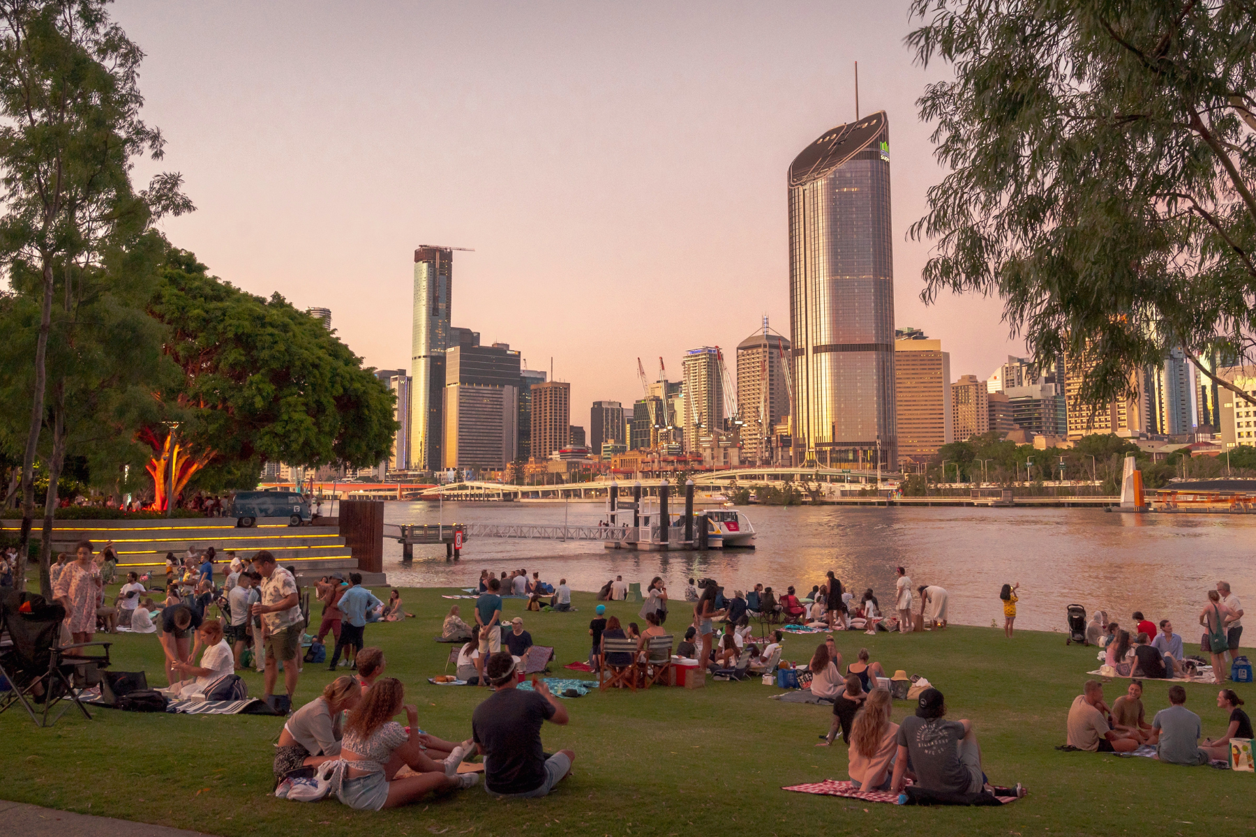 Students having picnics in park in South Bank, Brisbane