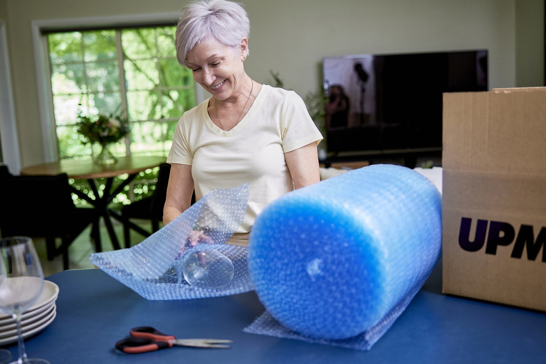retired woman using bubble wrap