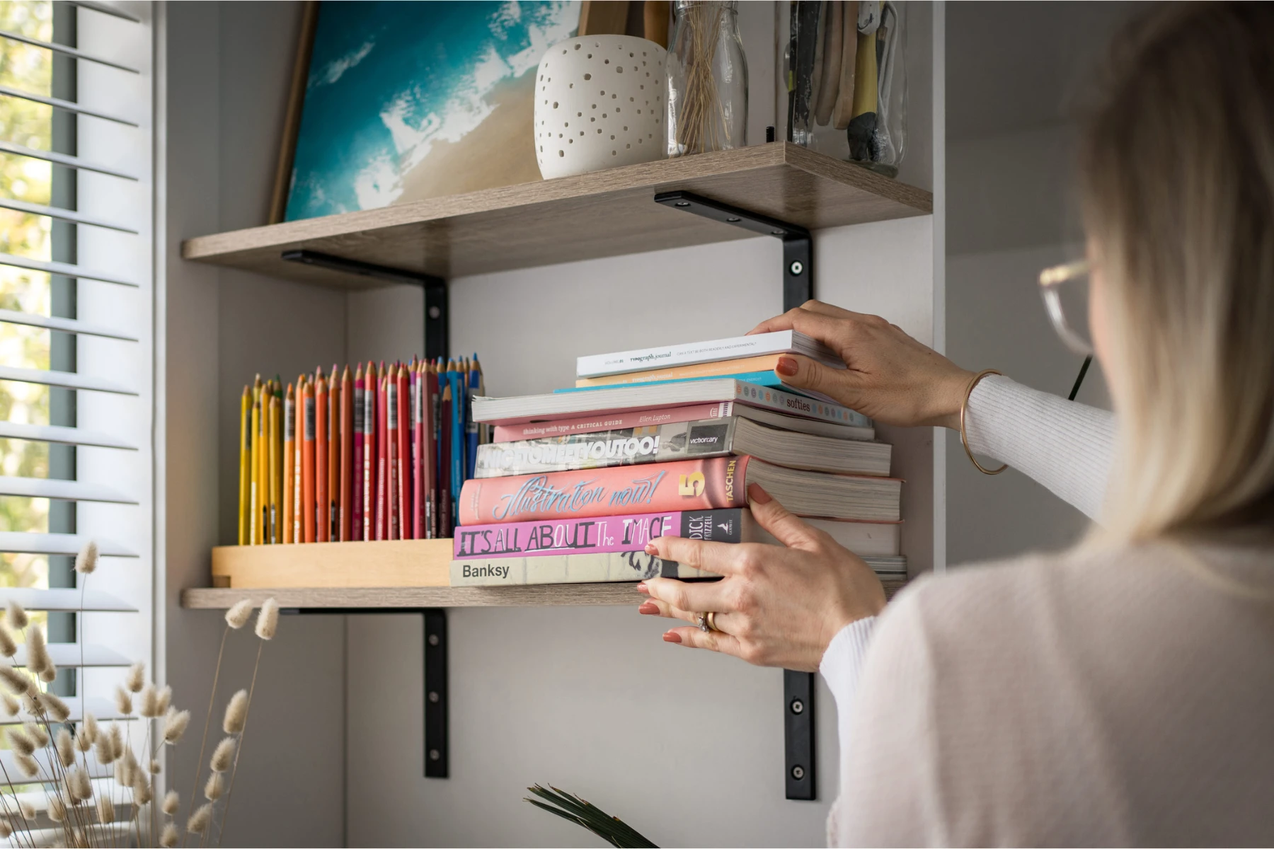 woman decluttering books