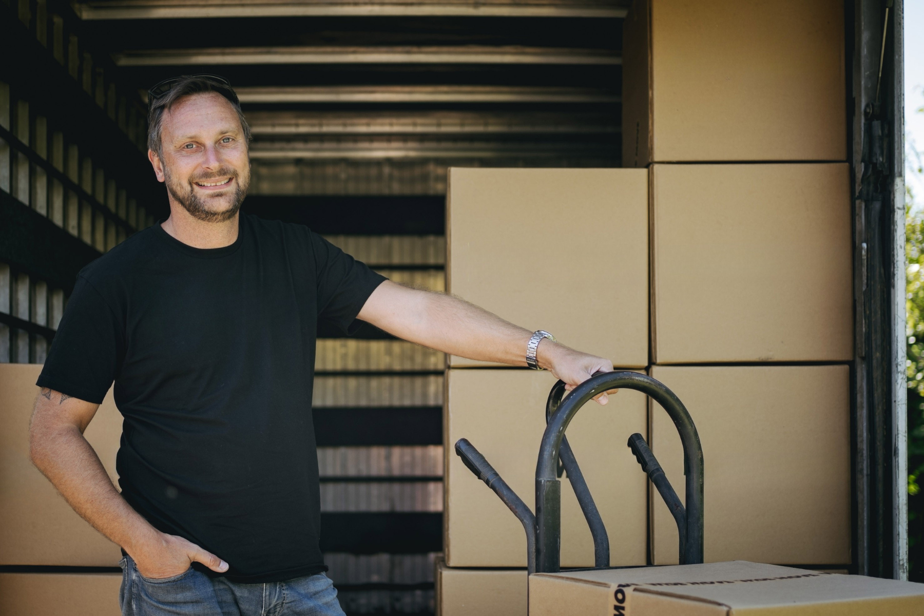 removalist with boxes near truck