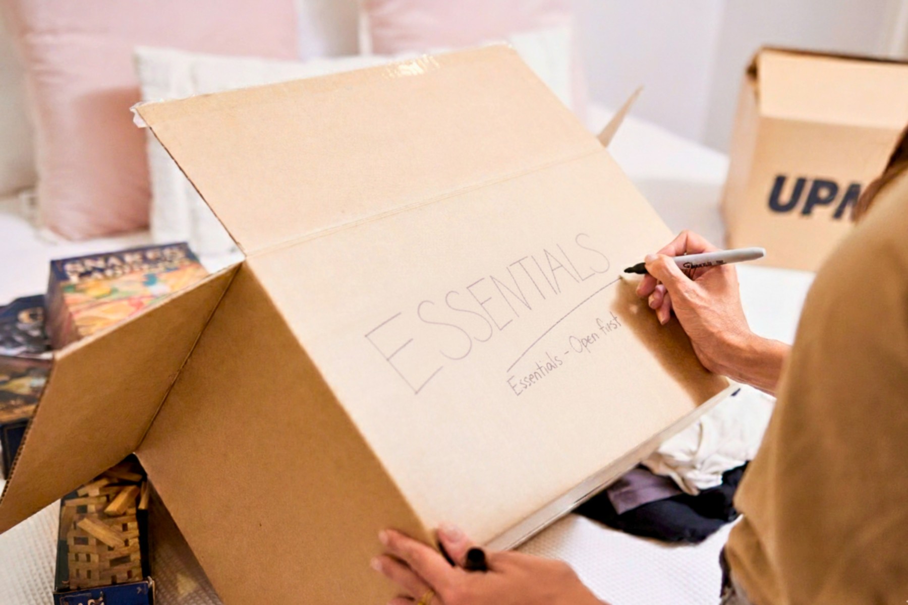 Women writing special label on her packing box