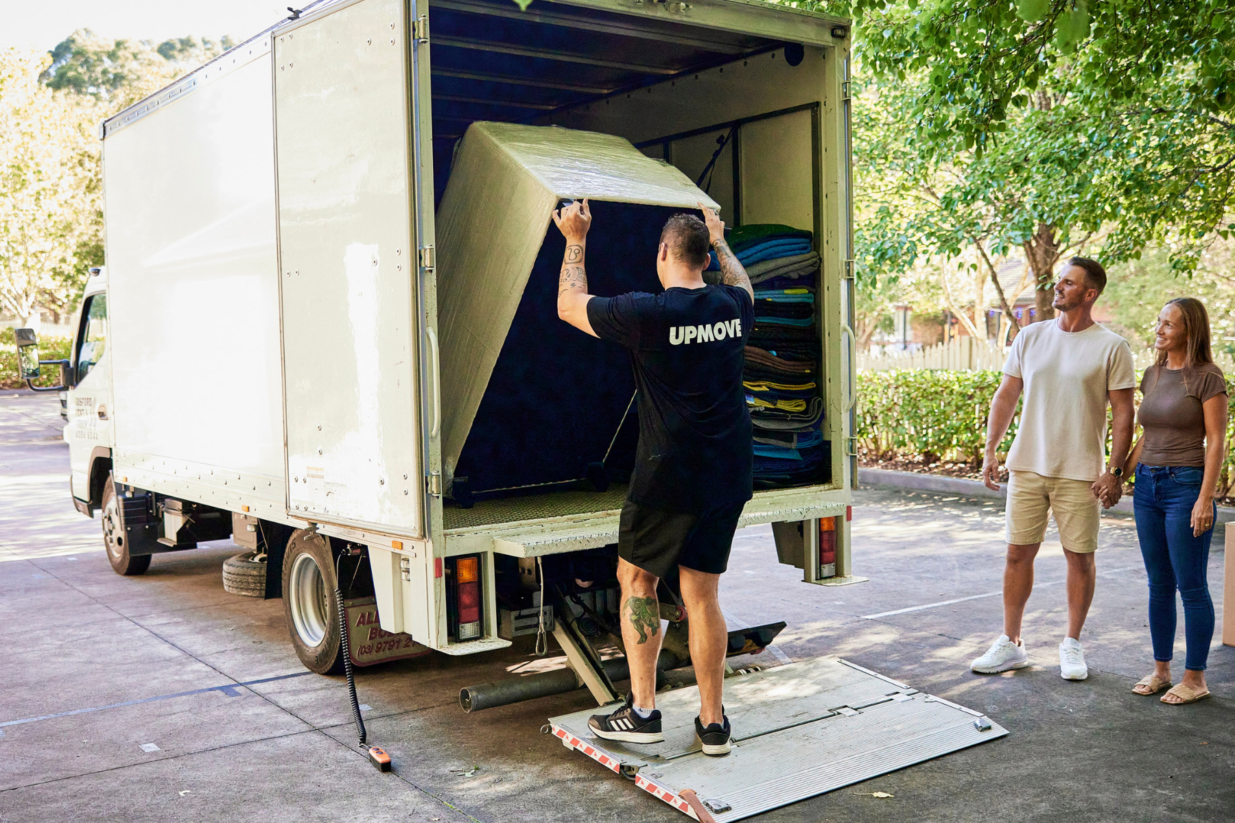 Upmove removalist team collecting an old couch and putting in truck