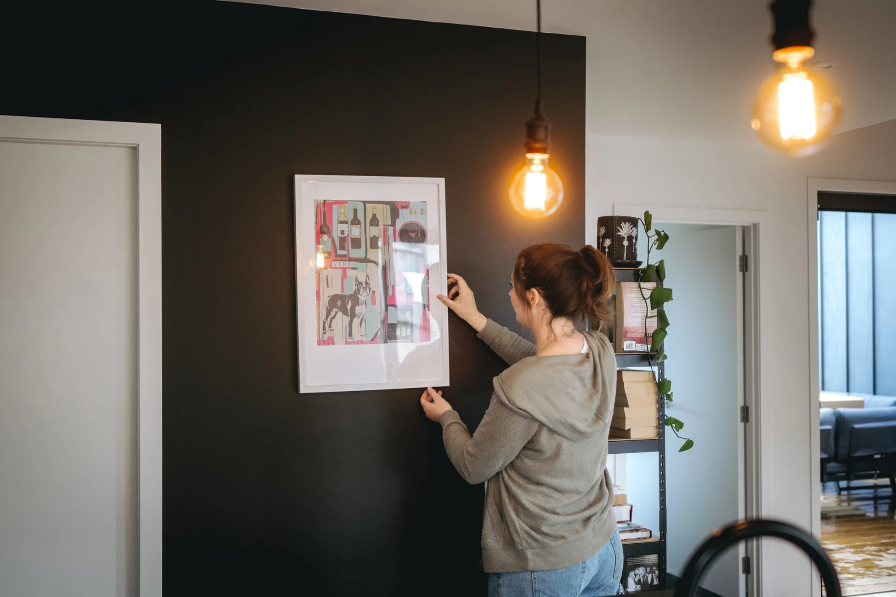 Woman removing art from wall